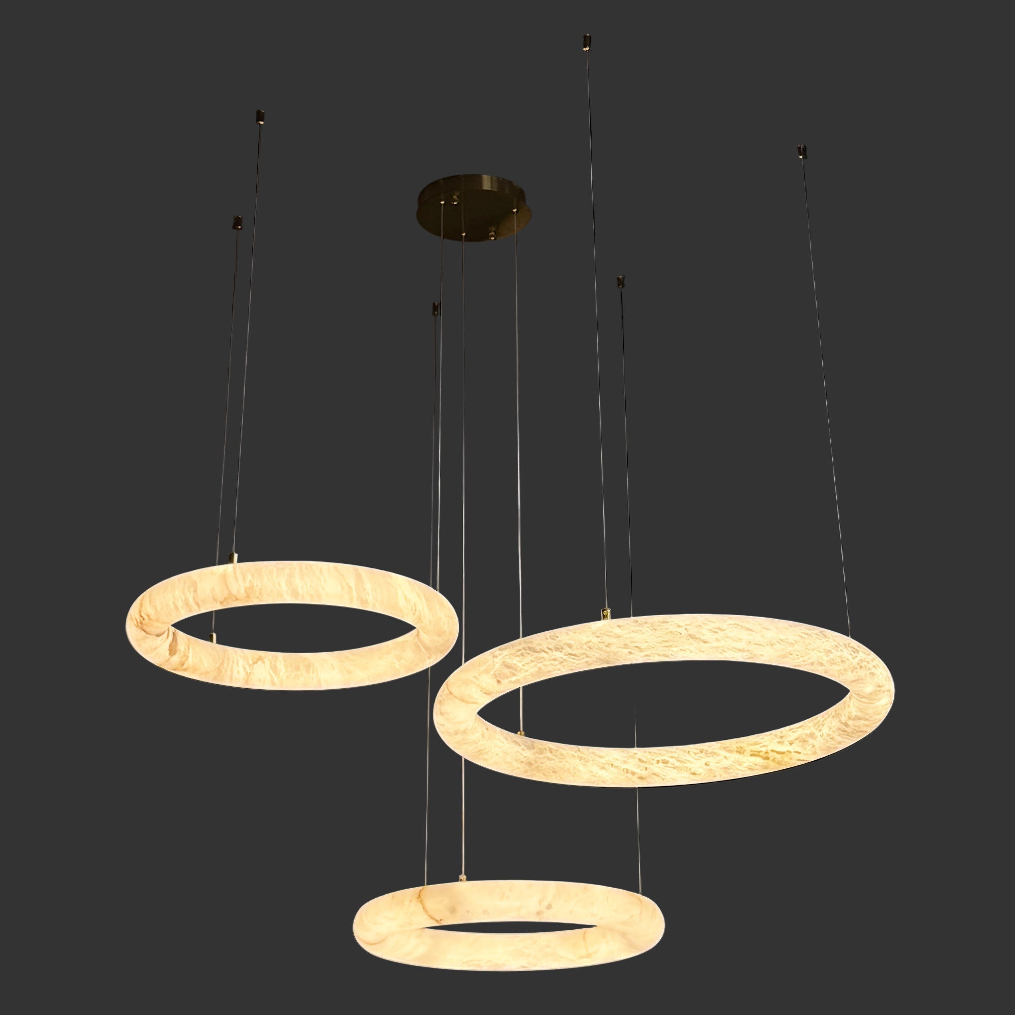 Alternate configuration of the Cavani Marble Trio Circular Chandelier with floating illuminated marble rings.
