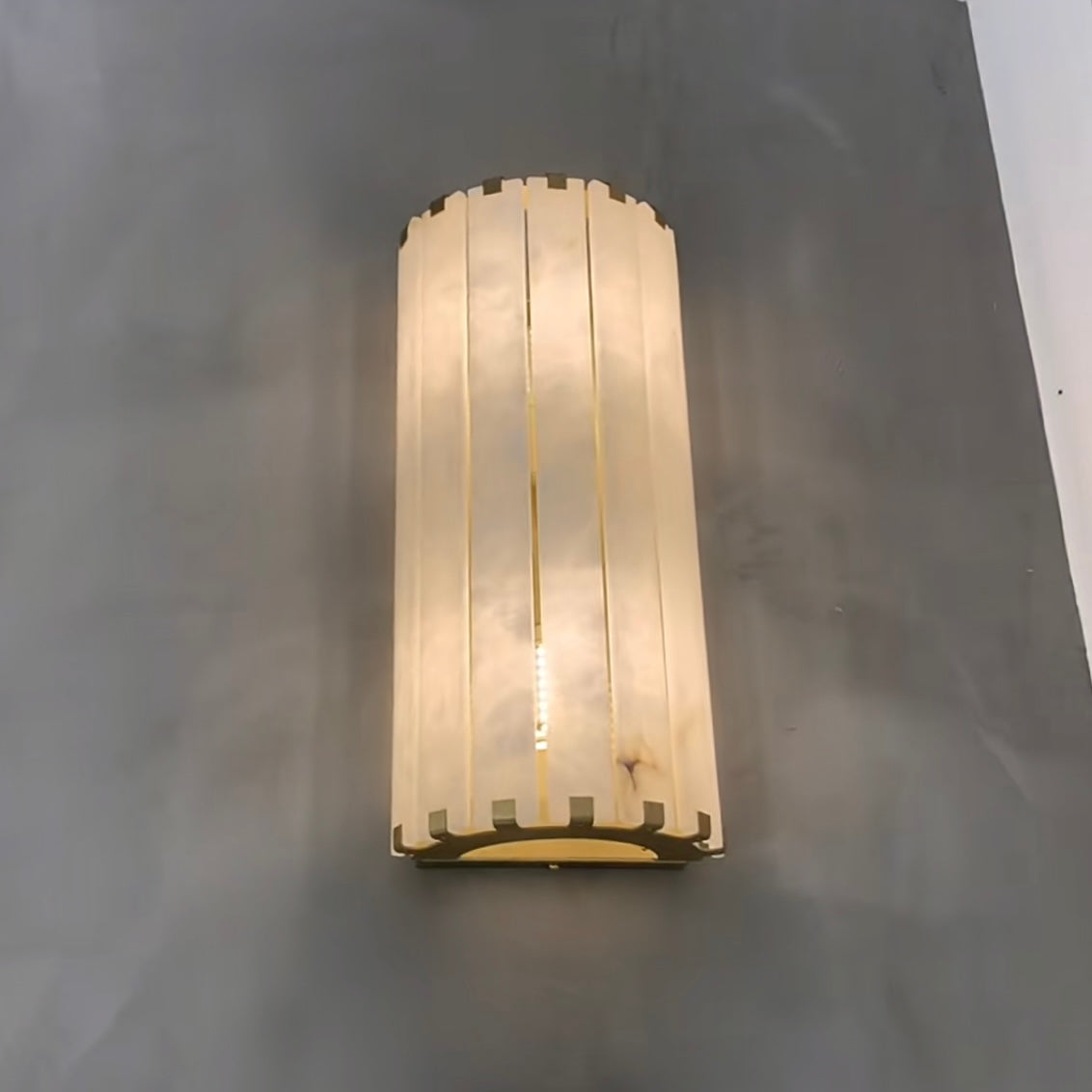cicci marble wall light close detail of marble panels and brass base