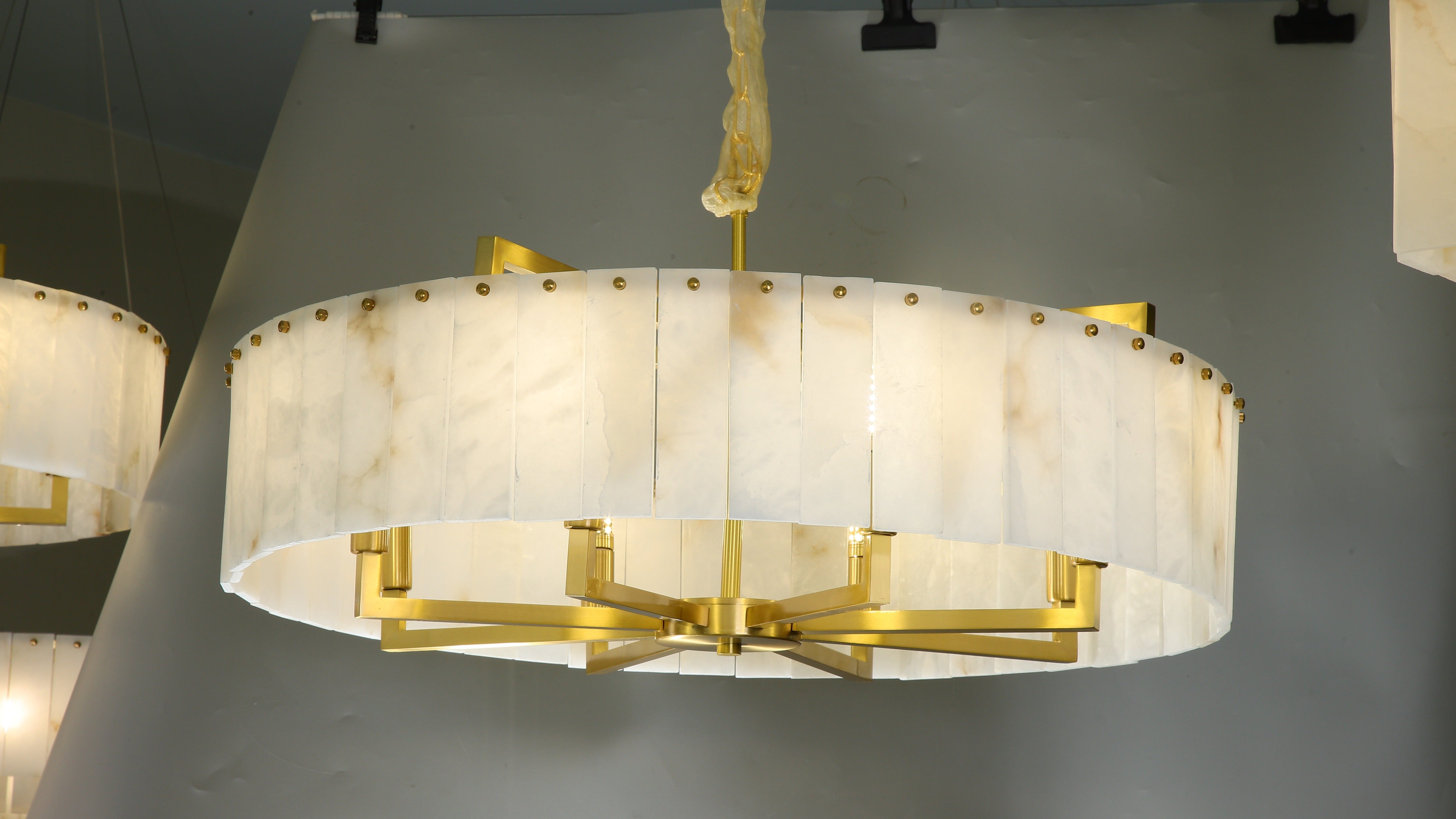 classisco circular chandelier with carved marble shade and refined gold frame