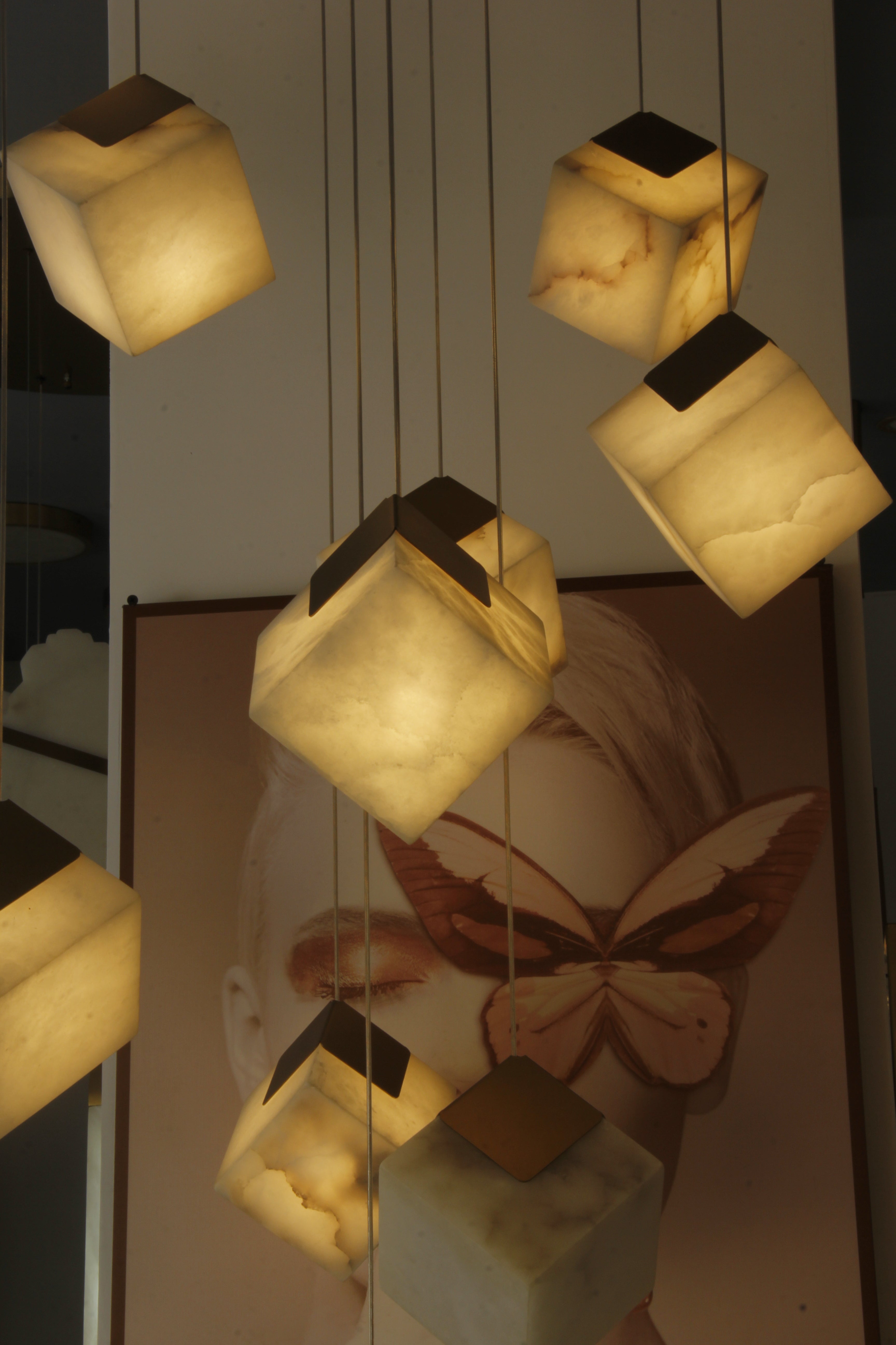 warm illuminated marble cubes suspended at varying heights for staircase voids