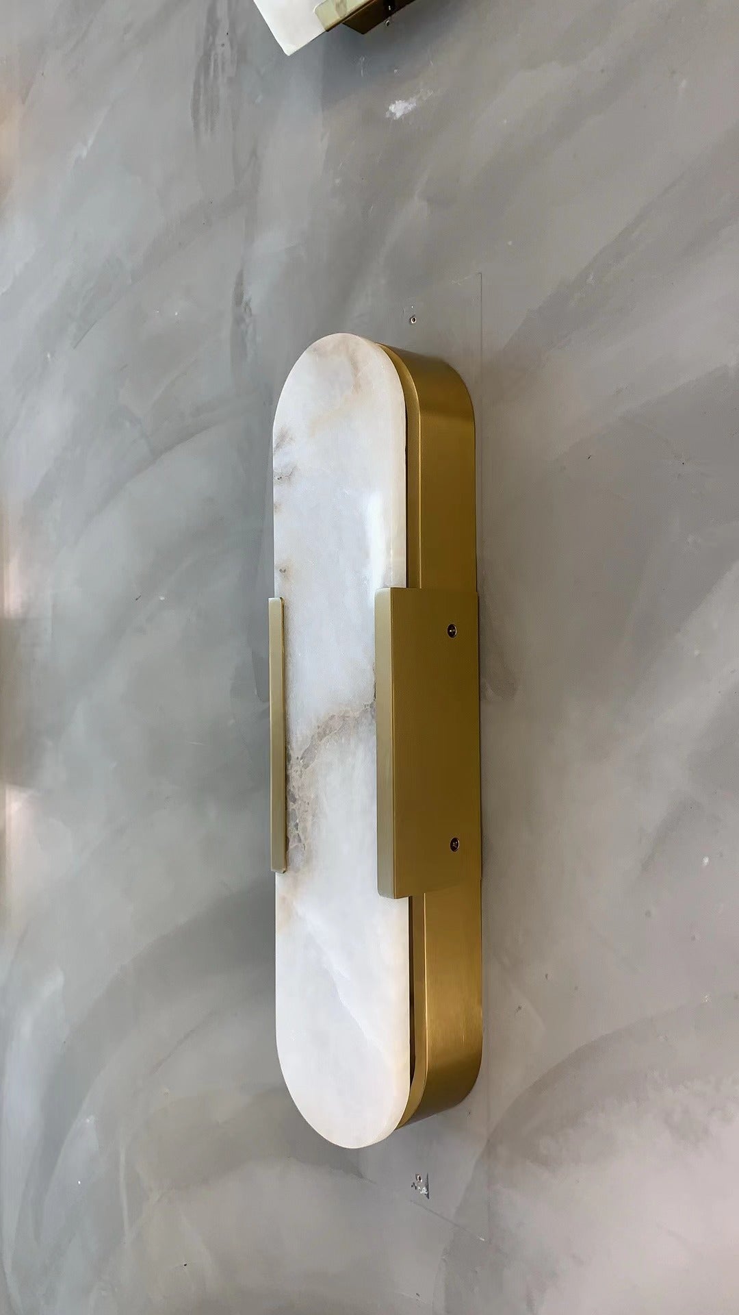 vertical alabaster-style marble wall light with diffused soft glow