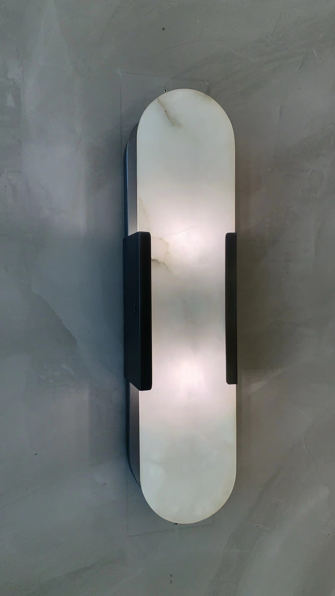 softly illuminated marble wall light showcasing natural stone patterns