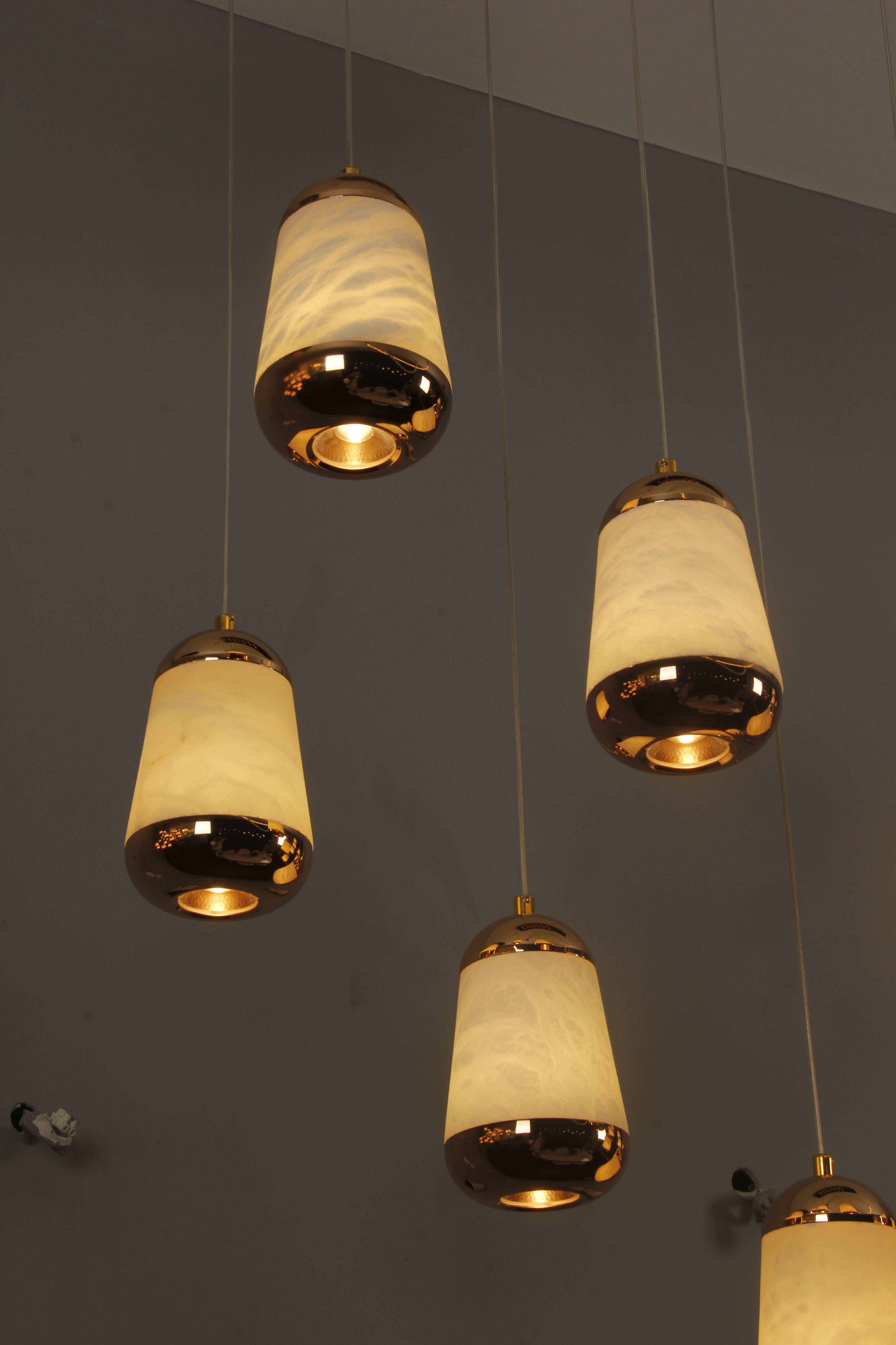 Giovanni chandelier teardrop marble-effect pendants cascading vertically from rectangular ceiling plate