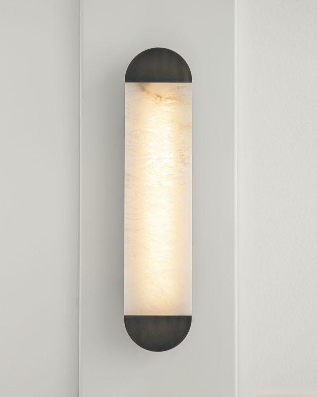 Marble wall light with contrasting metal caps and diffused warm lighting