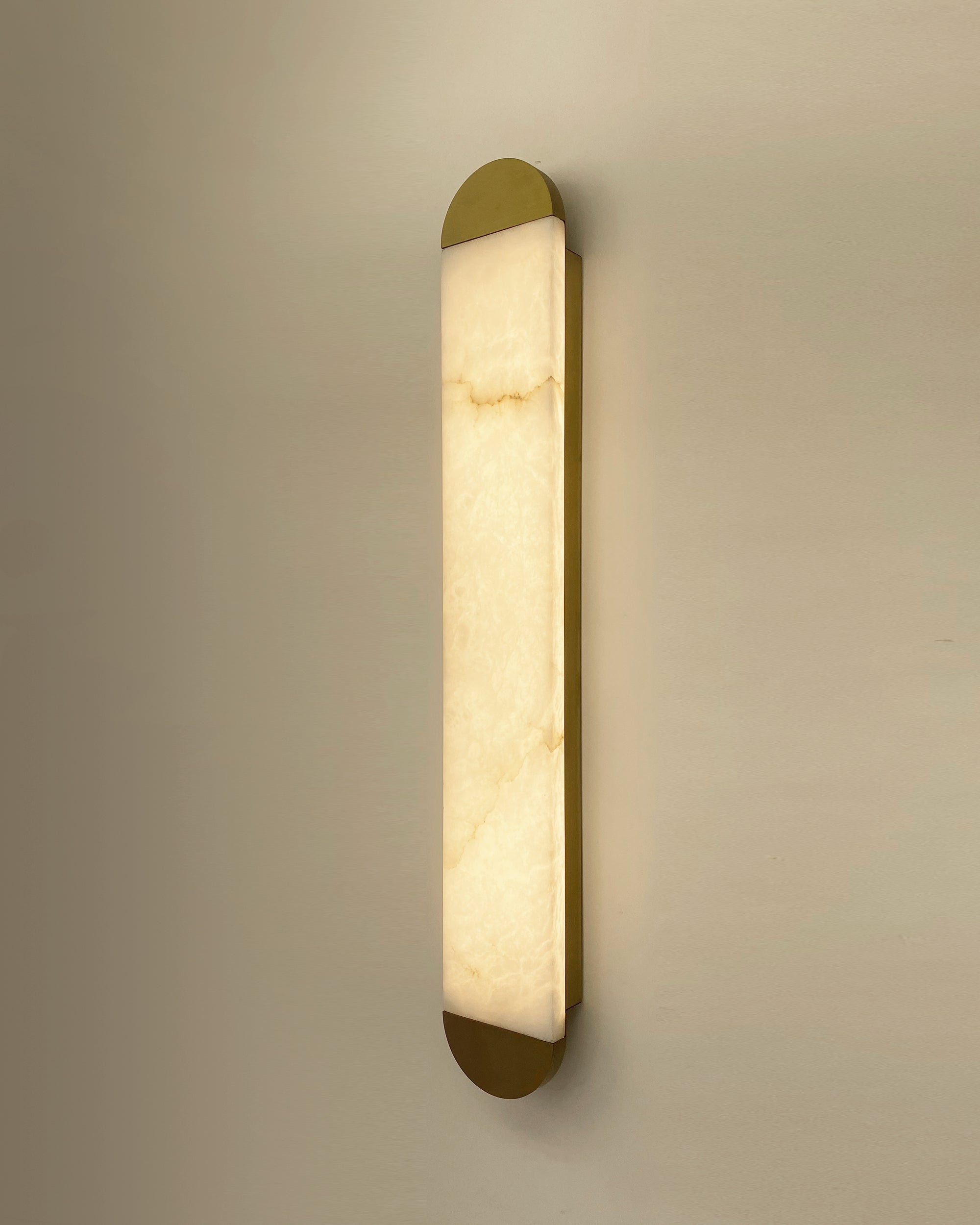 Modern interior styled with vertical marble wall light creating warm ambient atmosphere