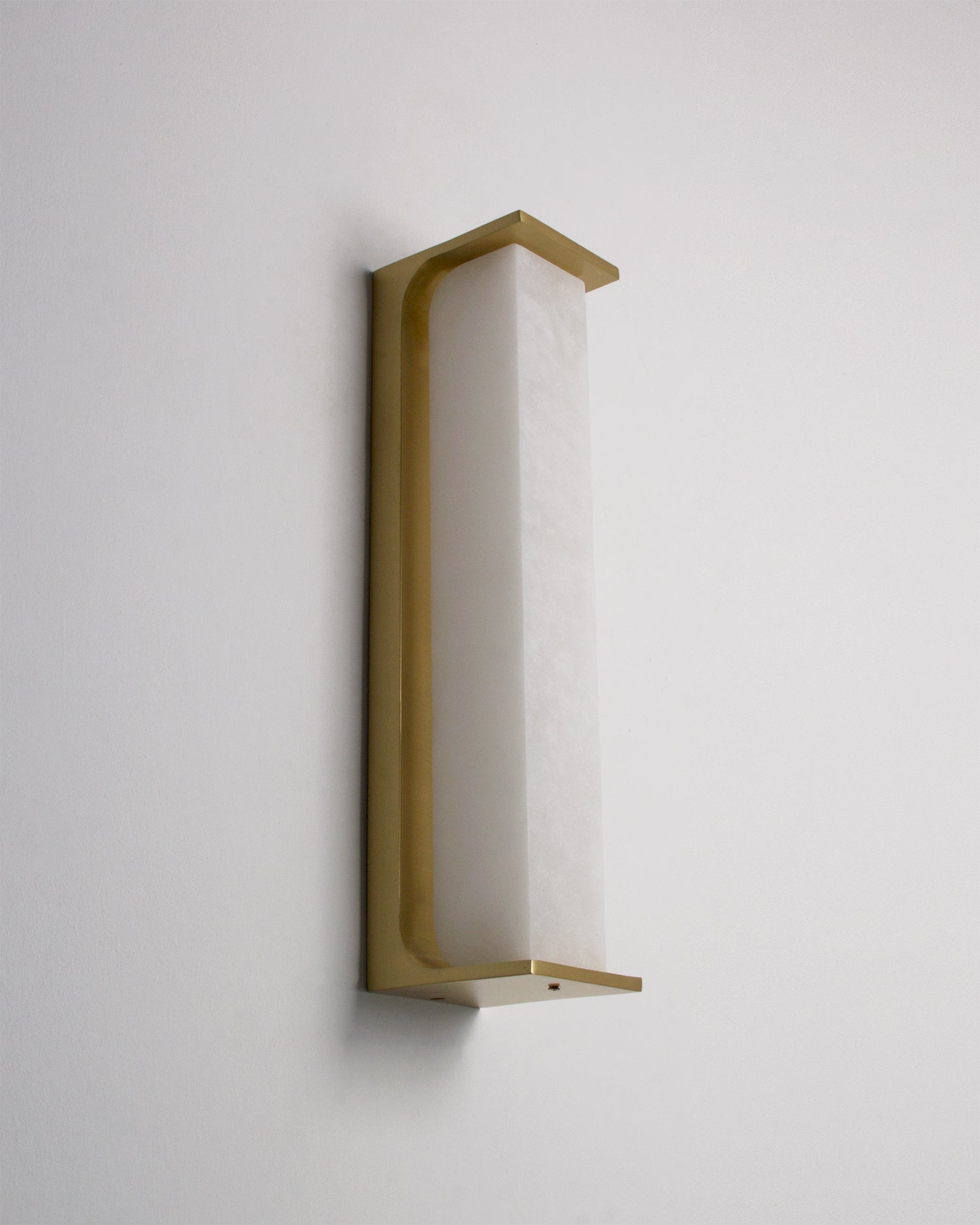 Side profile of the VORELLI Matera marble wall light showing its curved architectural silhouette and contemporary sculptural form