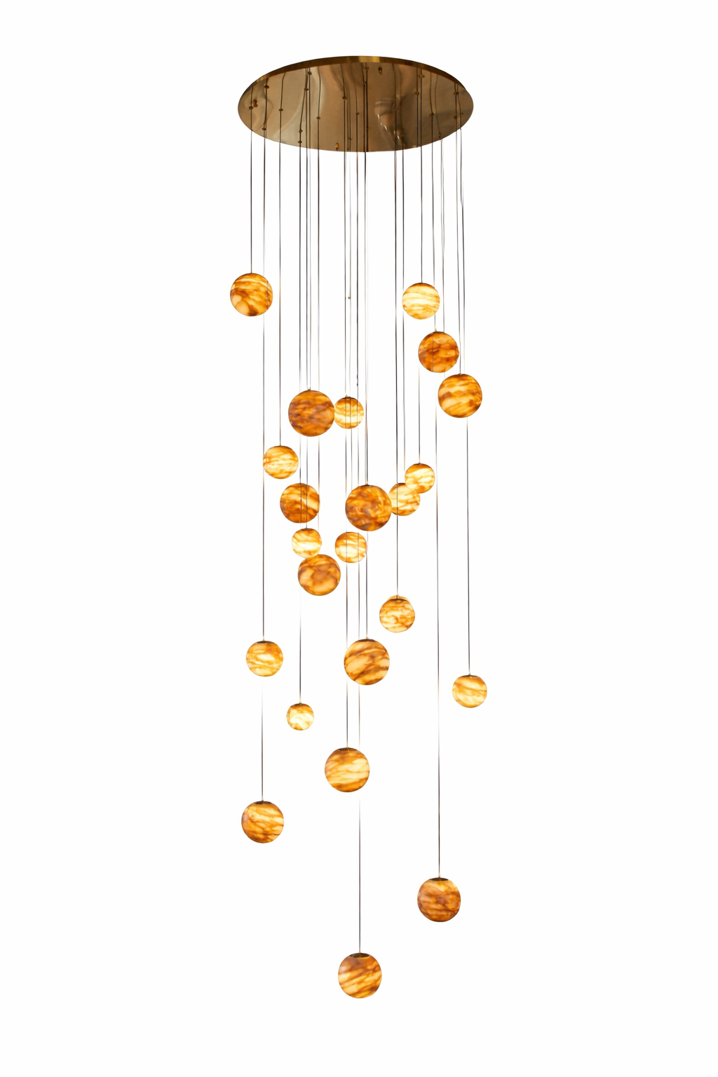 Luxury cascading marble sphere staircase chandelier with multiple illuminated natural stone globes suspended at varying heights from a polished circular ceiling canopy, isolated on pure white background