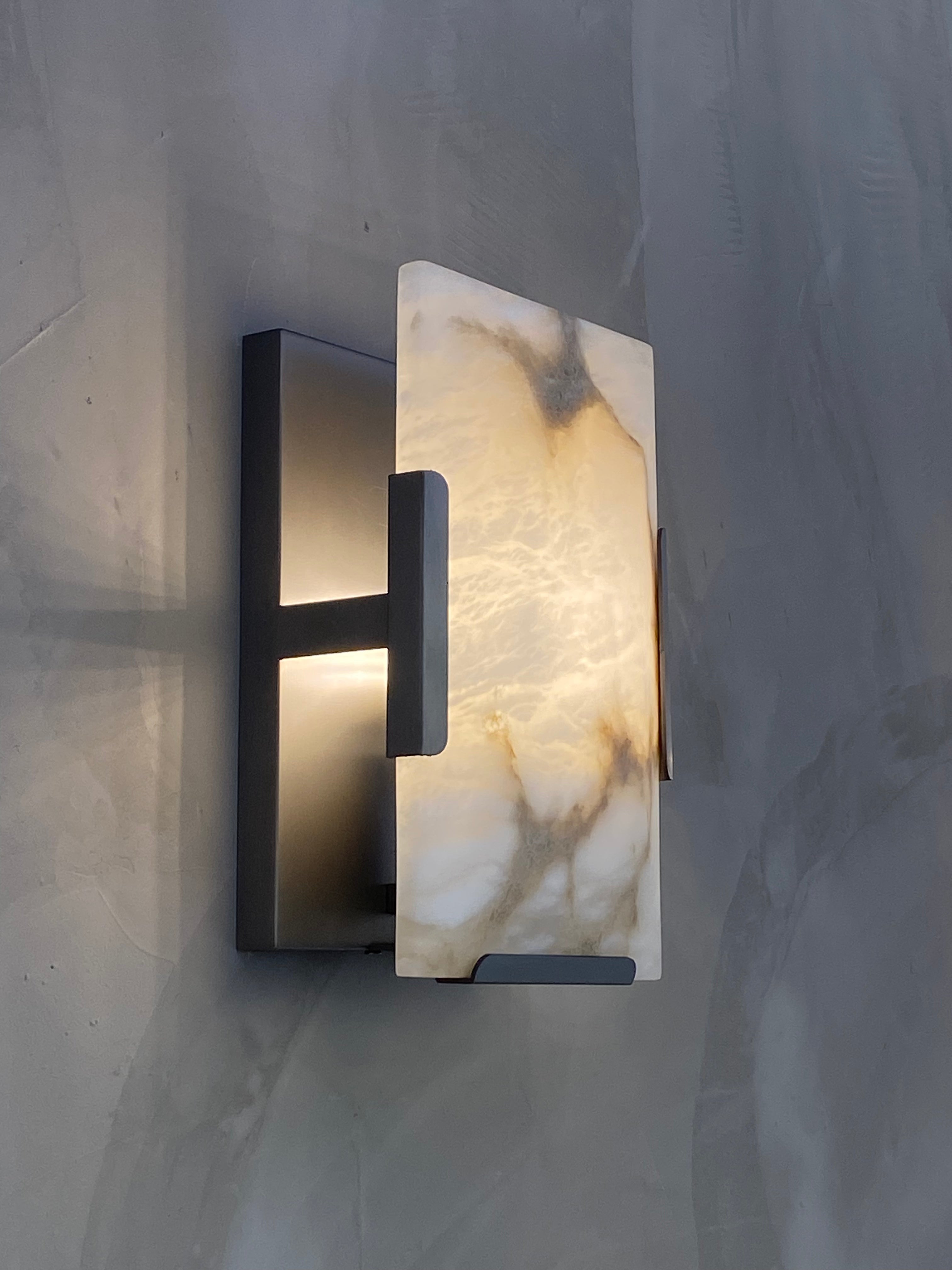 Side profile of Angel Marble Wall Light with black metal frame