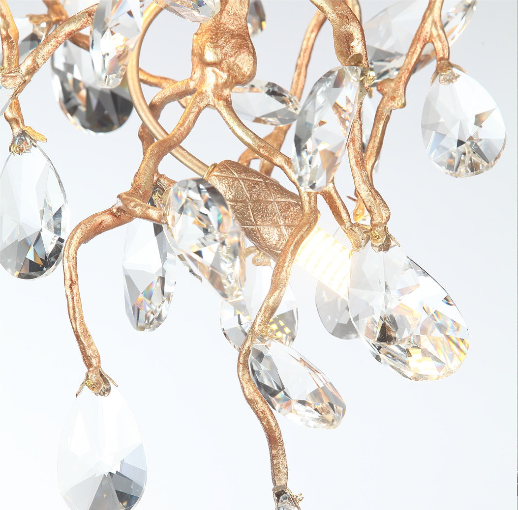 Arboré circular chandelier against a dark background showcasing the brilliant refraction of light through the crystal drops.