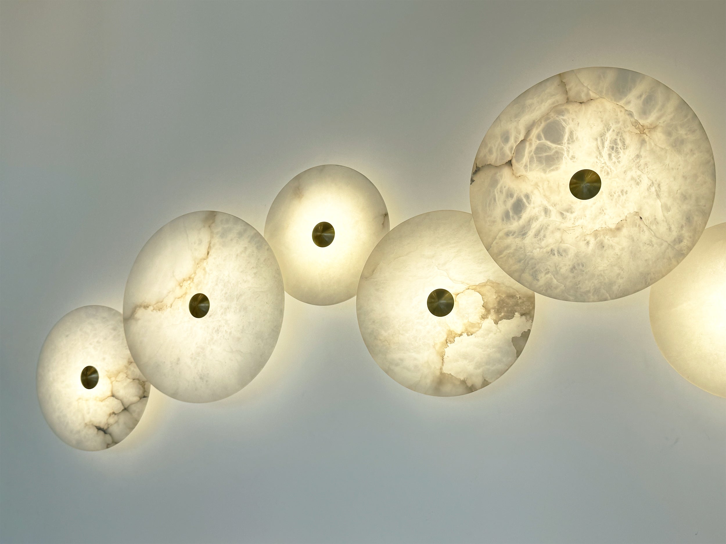 Aria Marble Wall Light round marble discs on white wall