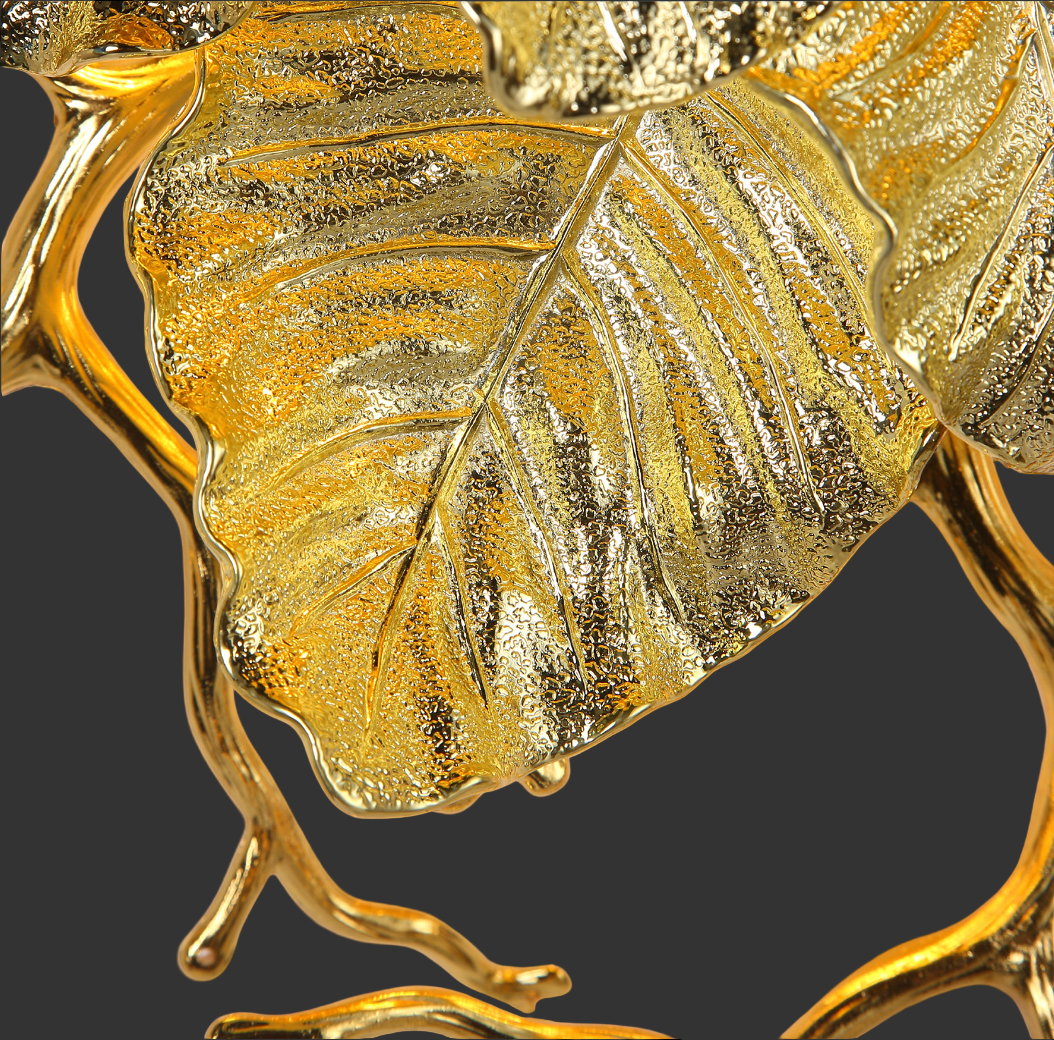 Detailed view of gold sculptural leaf element on Aurelia Wall Light II
