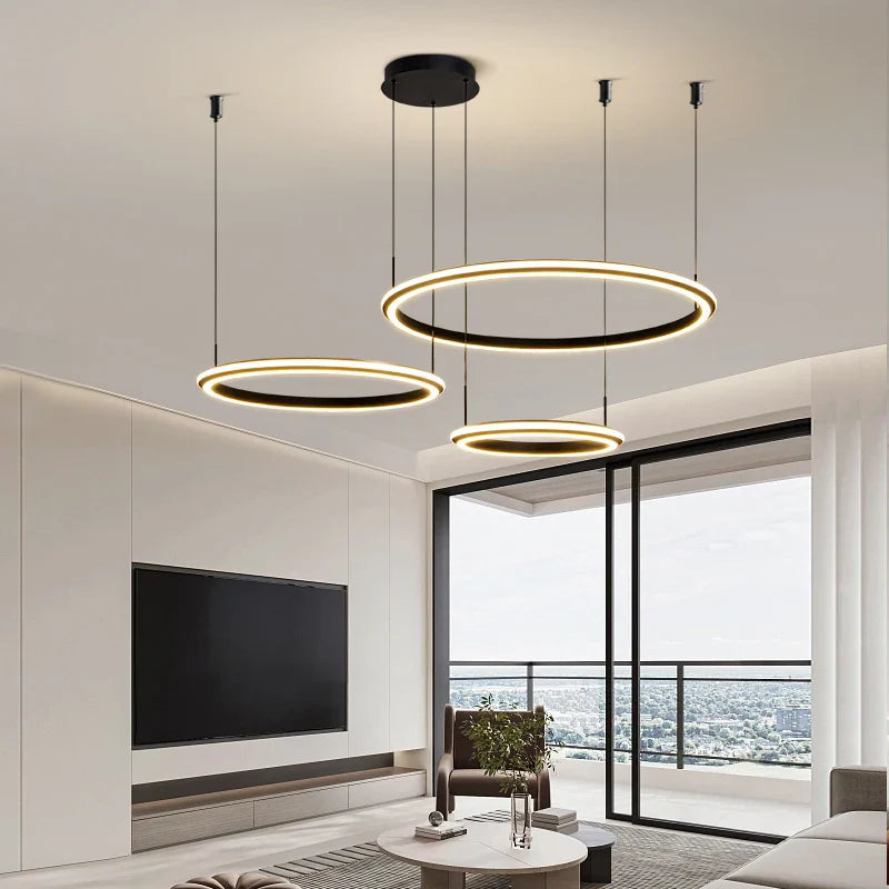 Three-tier circular LED chandelier above modern dining area