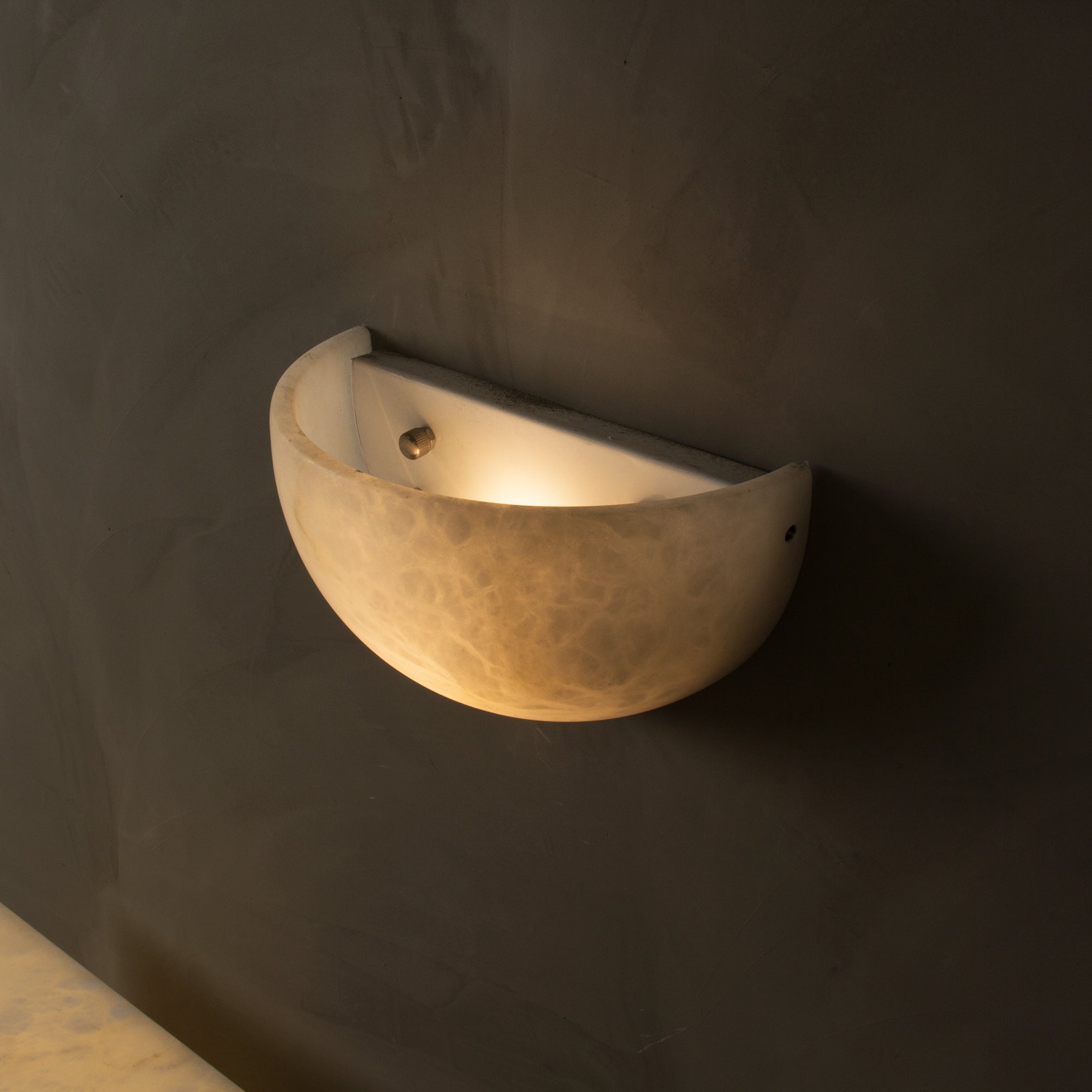 Belluno marble wall light showing soft upward light diffusion effect