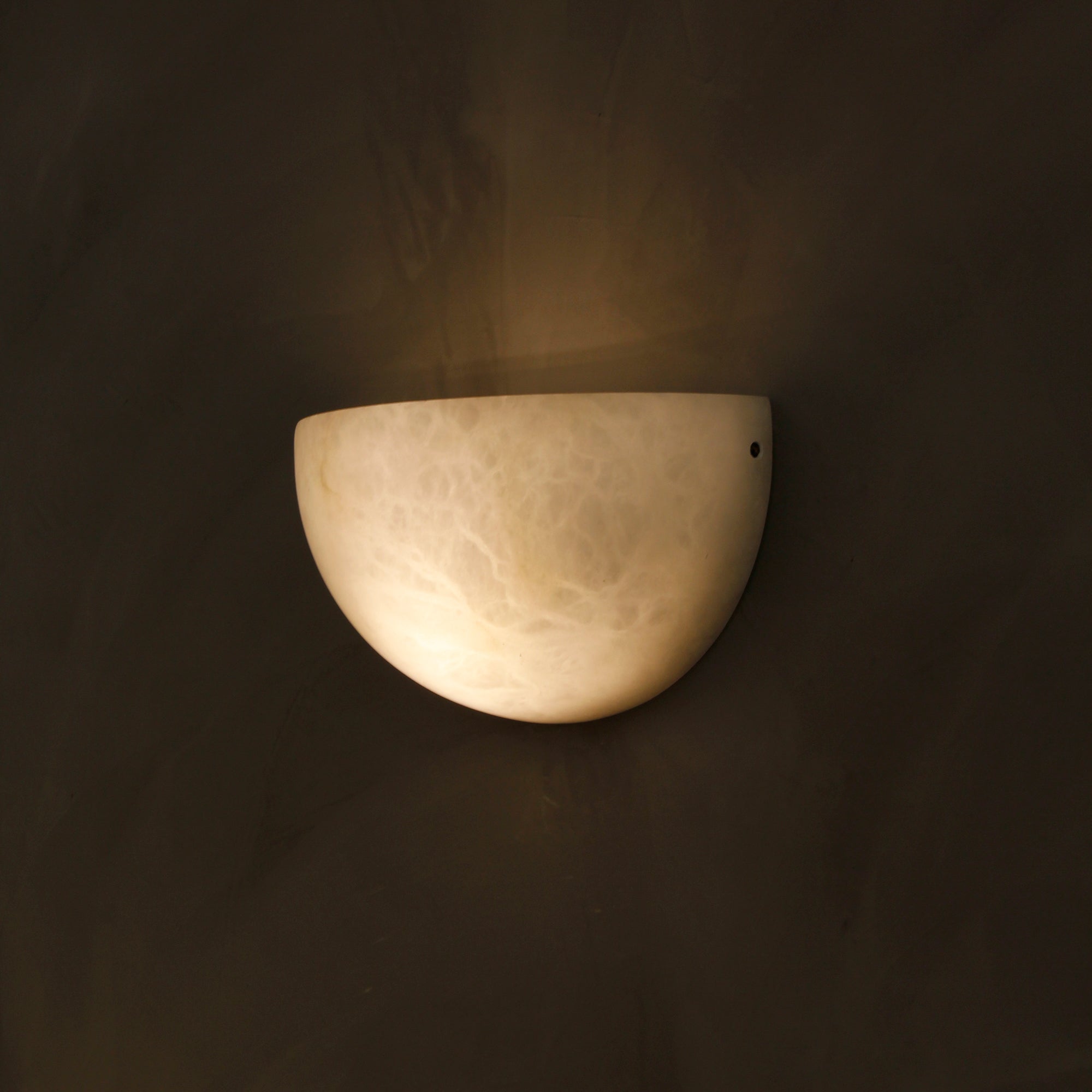 Belluno natural stone wall light creating warm evening ambience
