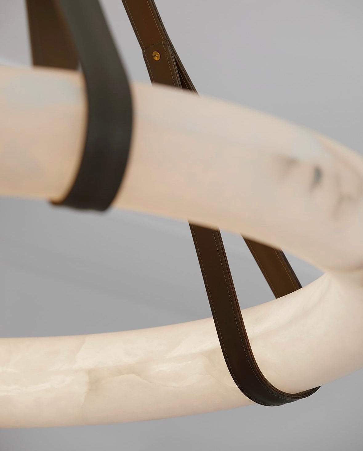 Close-up of Botticino alabaster marble and leather strap detail
