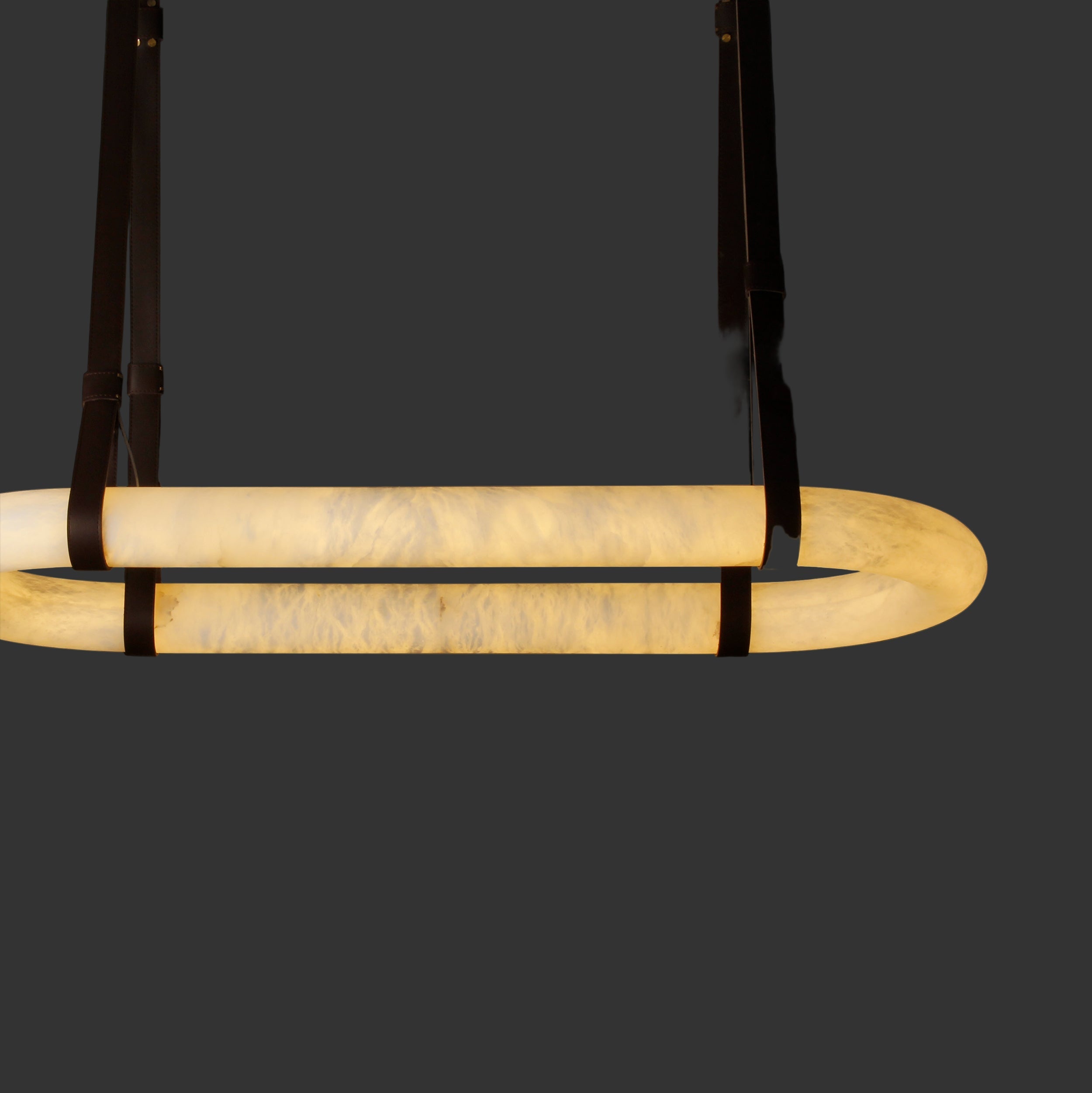 Side profile of illuminated Botticino marble rectangular chandelier