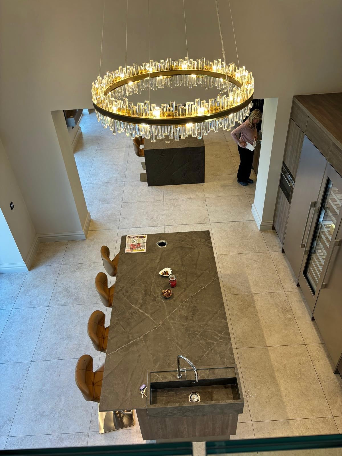 Top view of Brighouse circular chandelier above a modern kitchen island with crystal bars