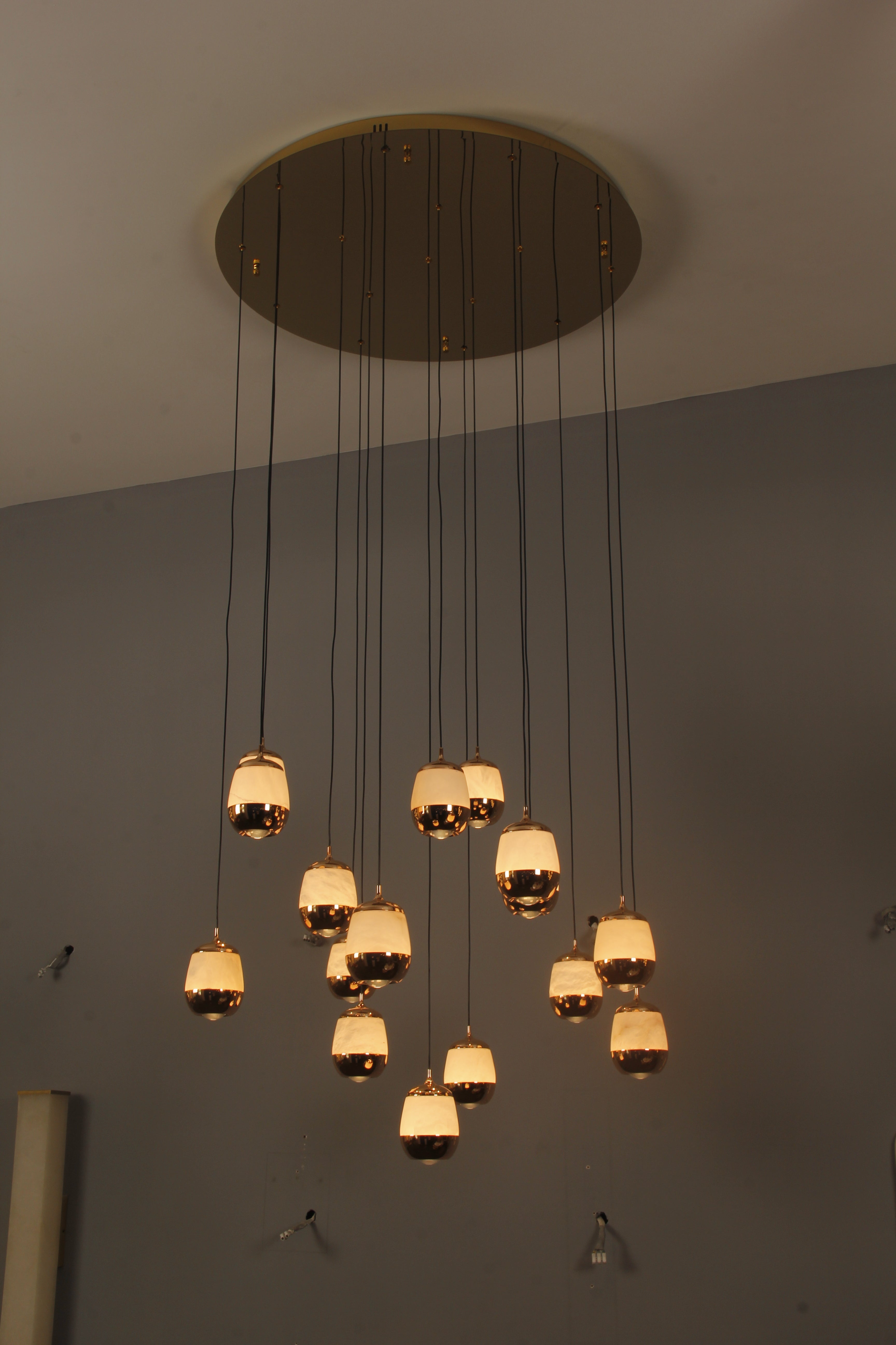 Caldera marble chandelier installed in luxury staircase interior