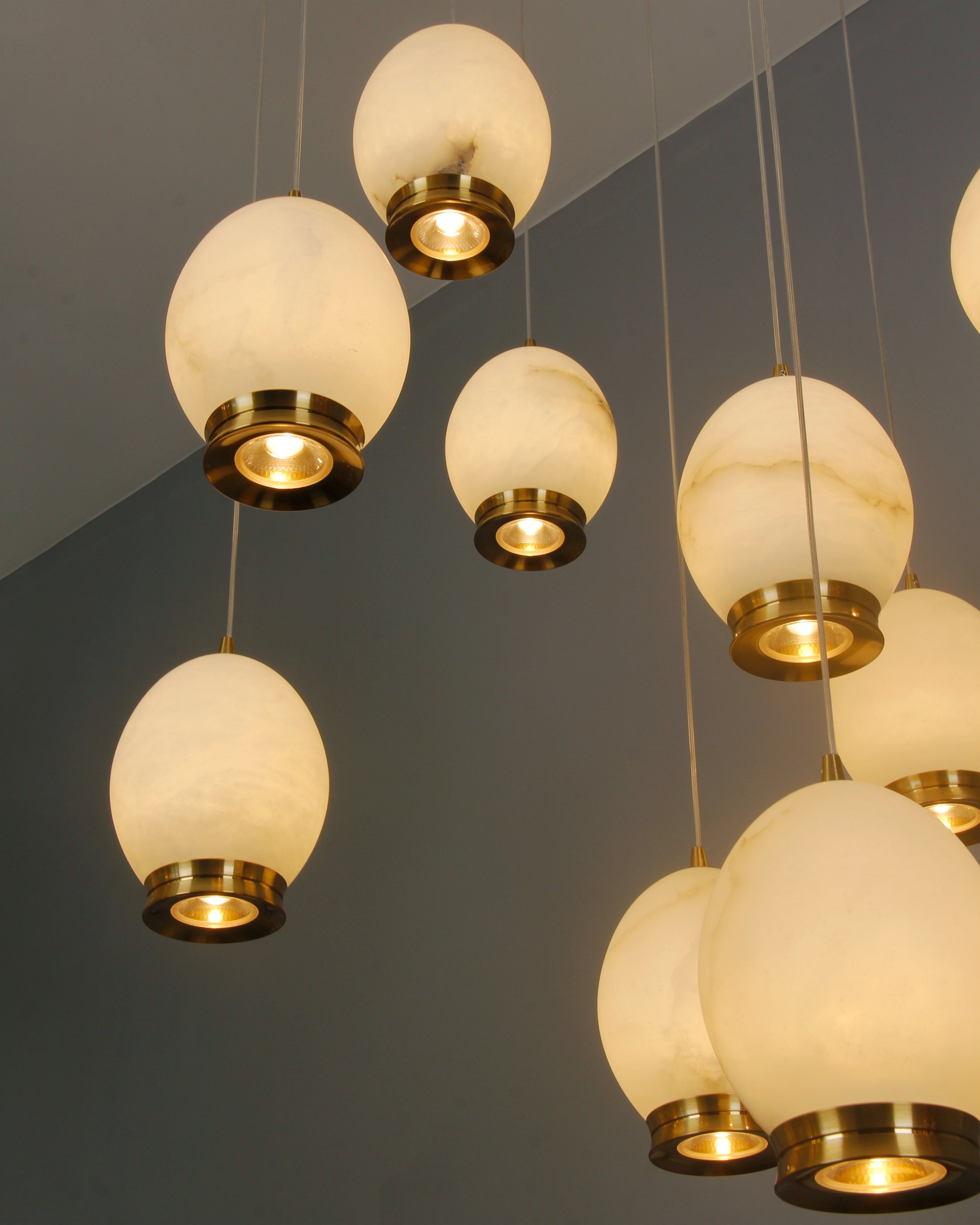 Cluster of marble pendant lights with brass detailing