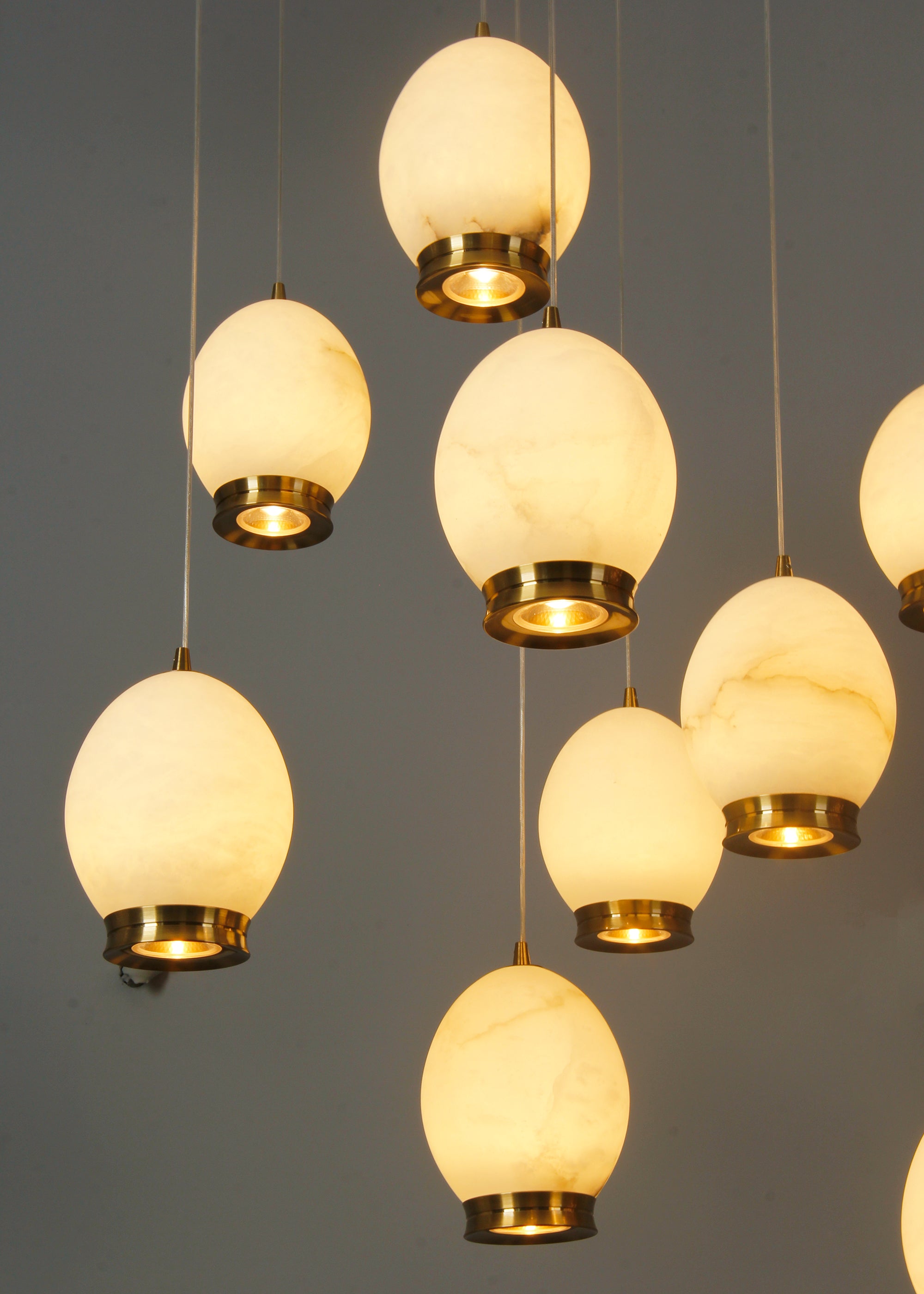 Caledonia marble chandelier installed in double height staircase