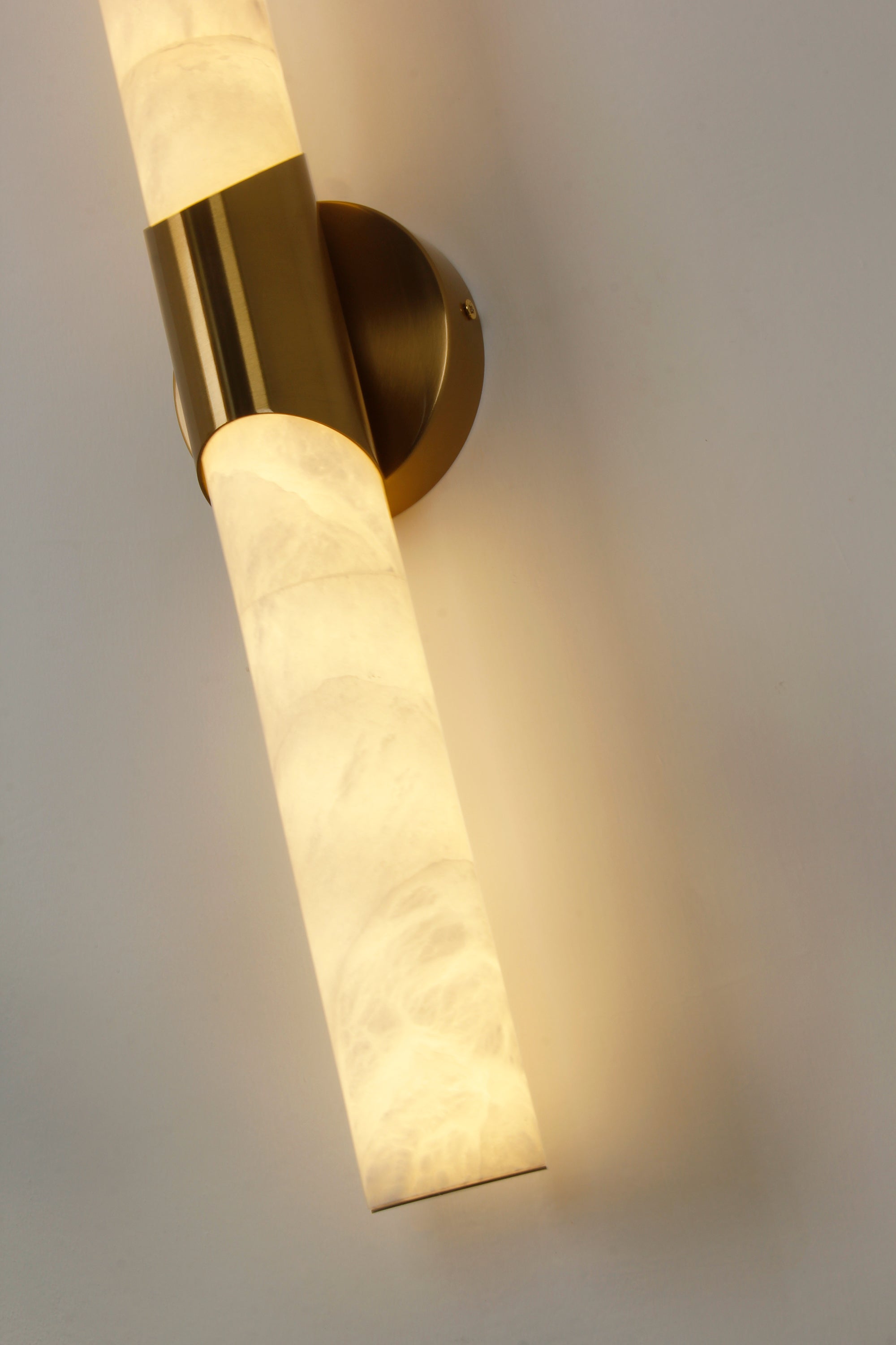 cilindro marble wall light angled perspective with contemporary soft lighting