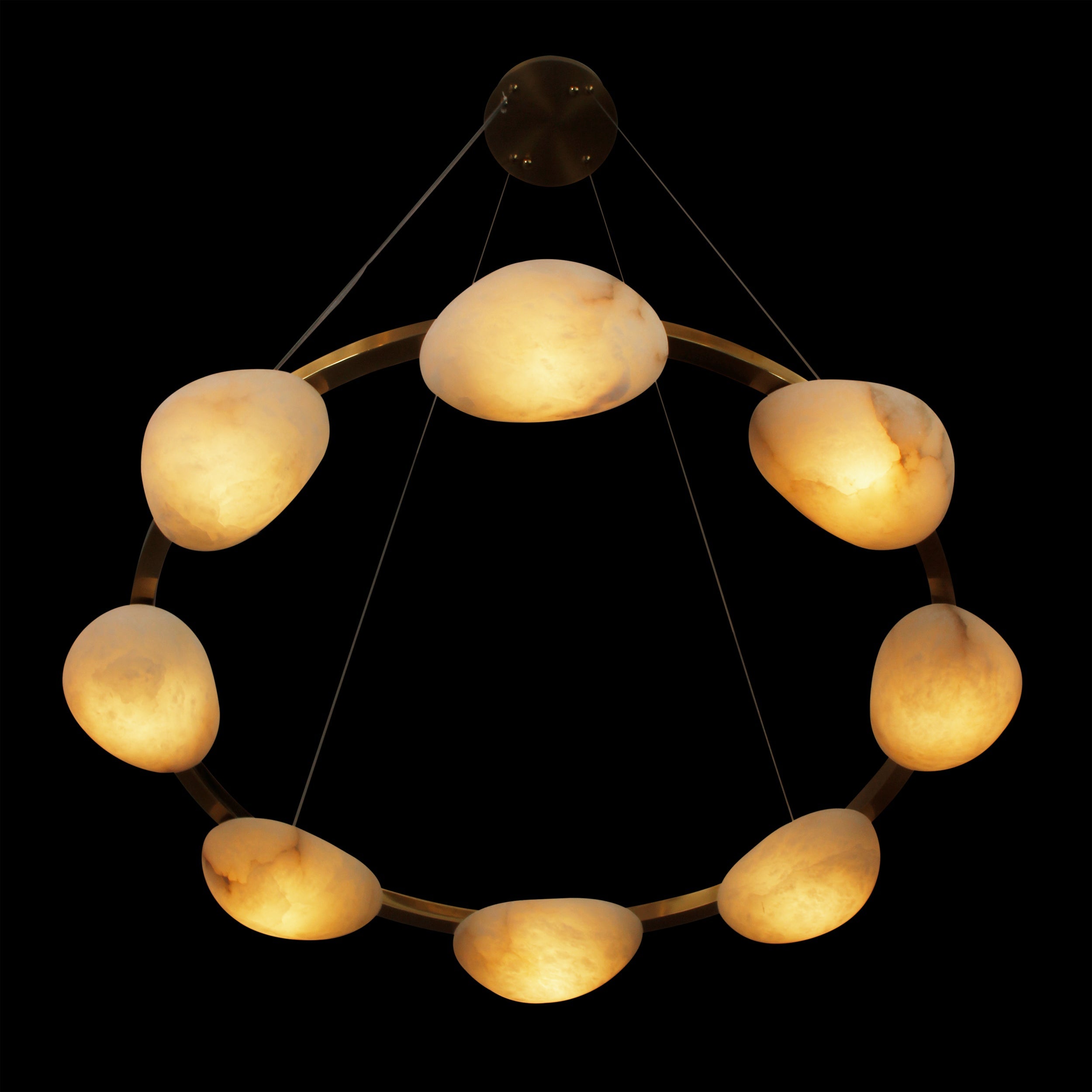 Top view of circular marble halo chandelier with warm glow