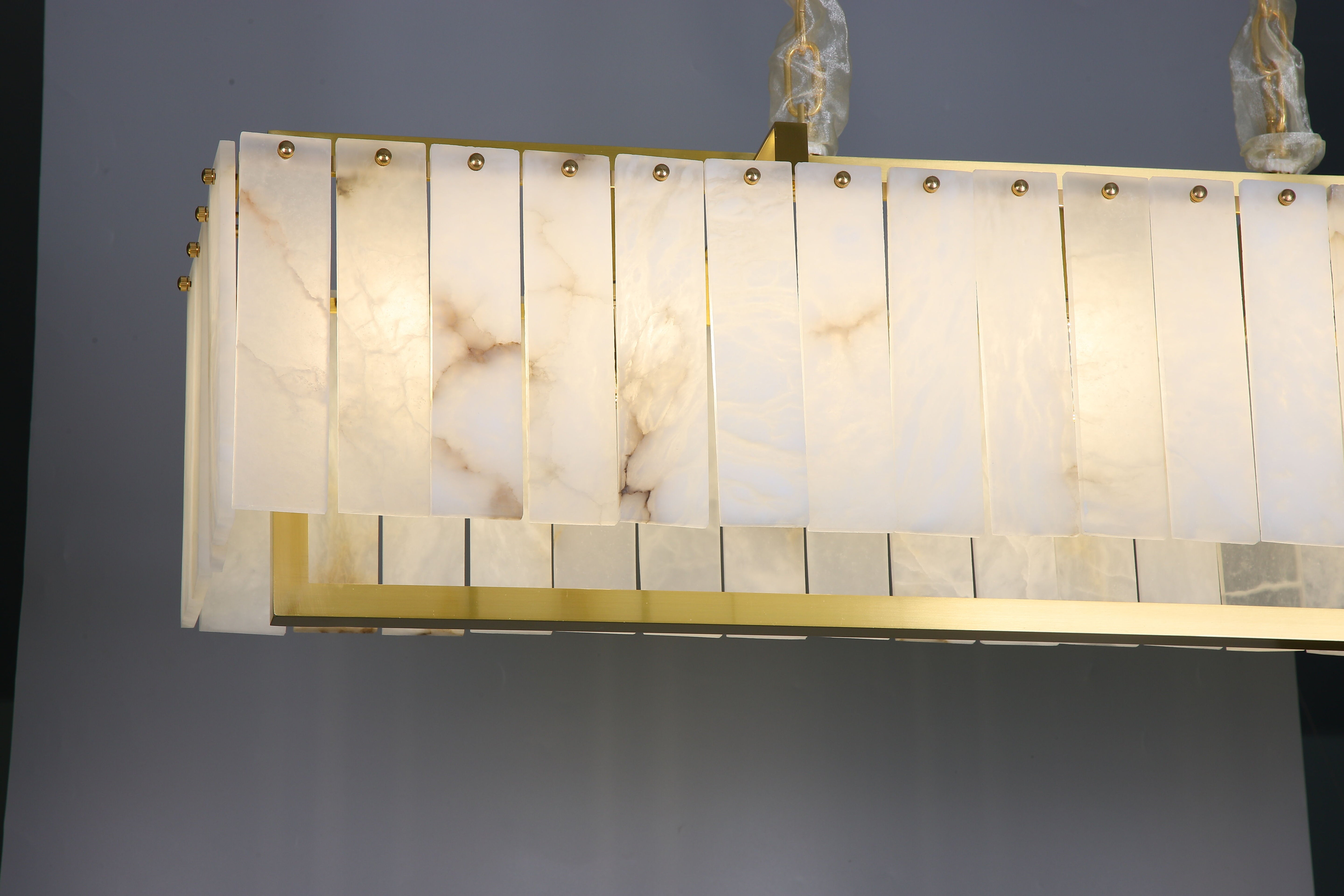 classisco chandelier side profile showcasing marble panels and suspended design