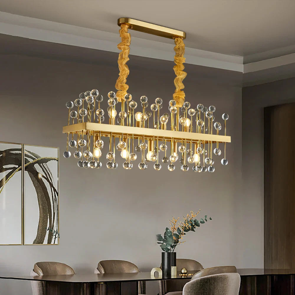 Alytus rectangular gold chandelier above dining table in Dubai
