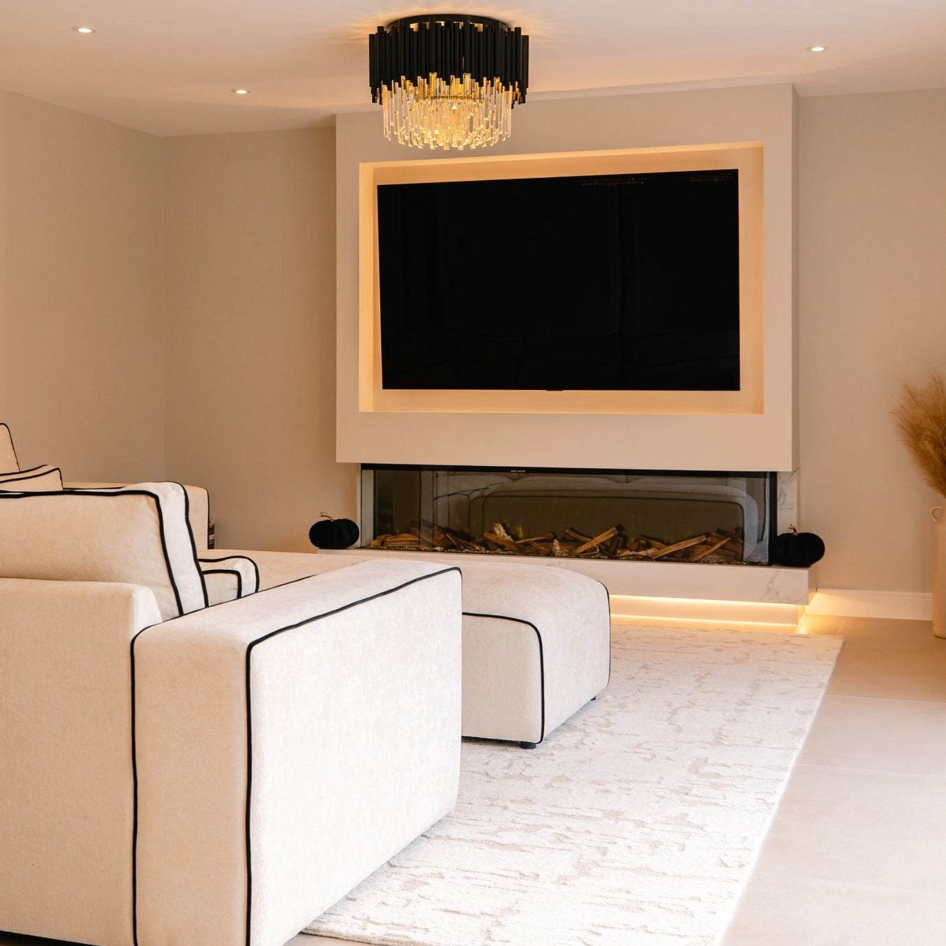 Luxury Gotham ceiling light illuminating a modern open-plan living room interior.