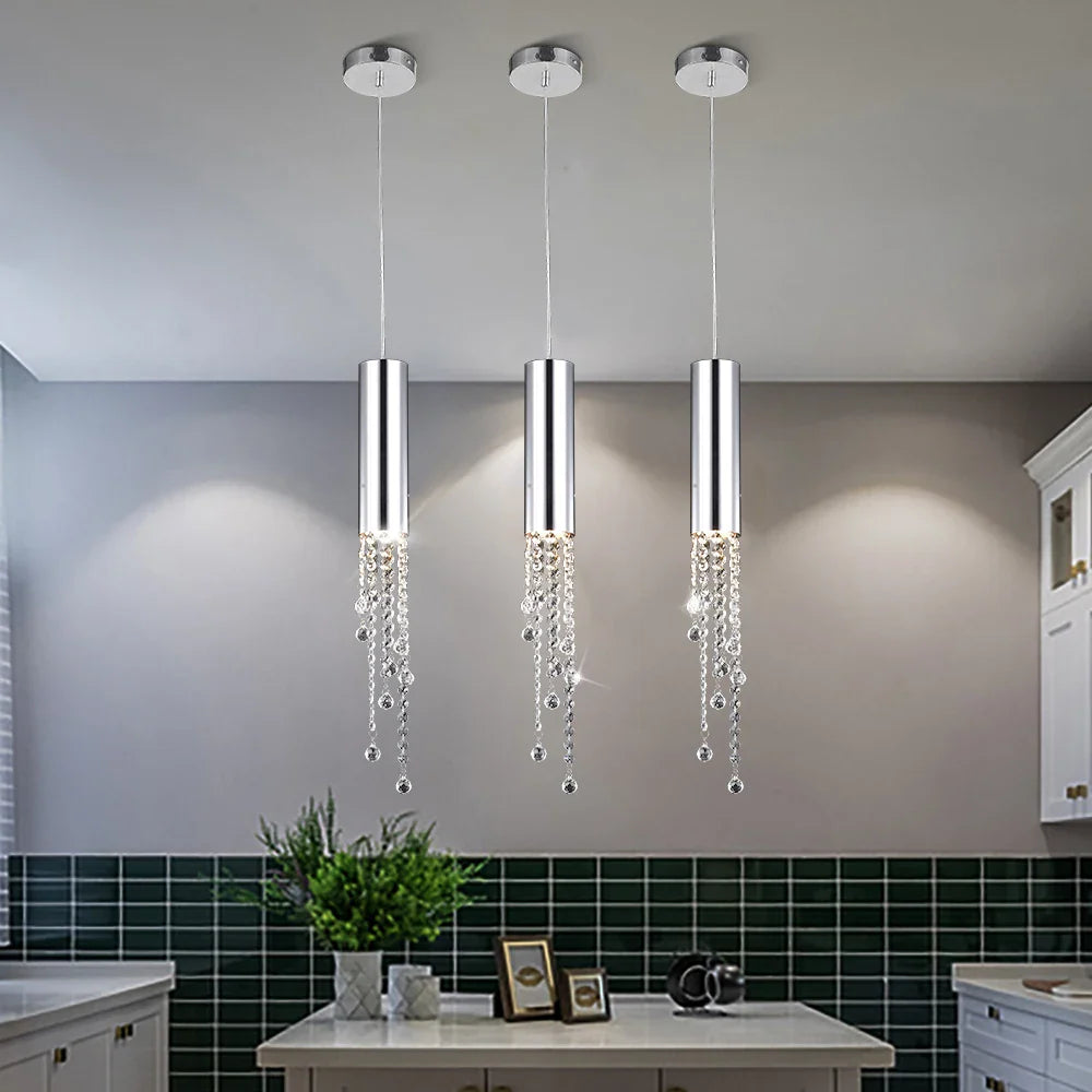 Grosvenor Pendant featuring diamond cut octagon crystal chains installed above a luxury kitchen island