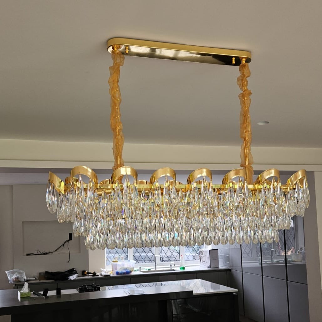 Isso Rectangular Chandelier suspended within an elegant living and dining interior setting