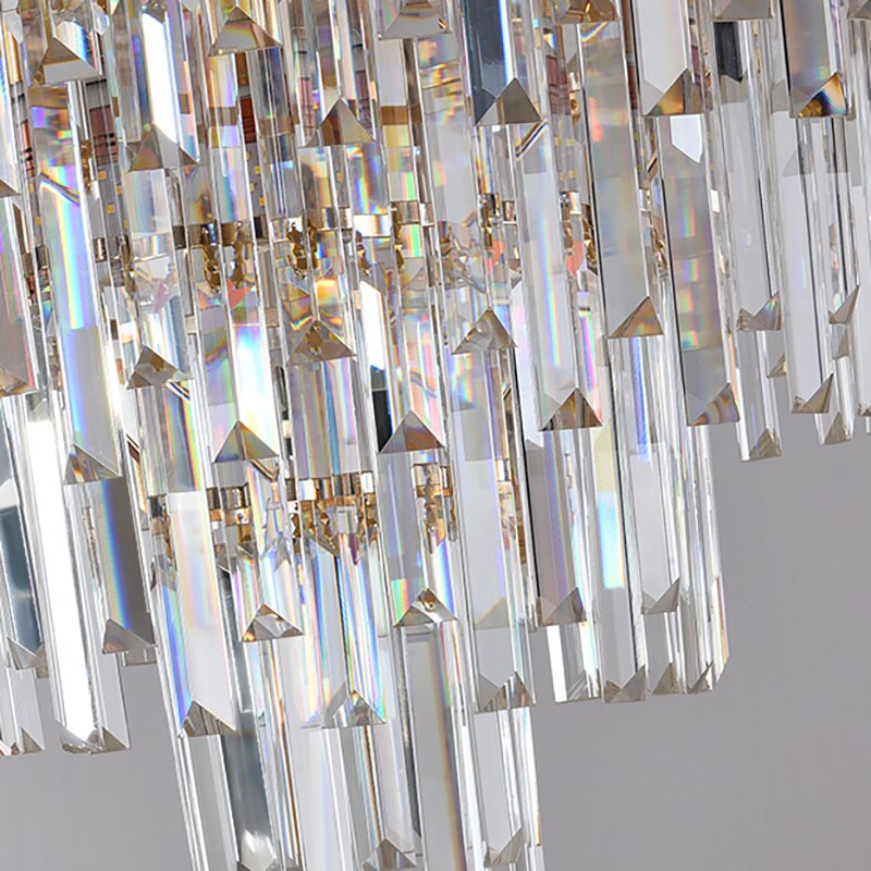 Alternating crystal bars beneath tiered frame creating dramatic luxury lighting effect