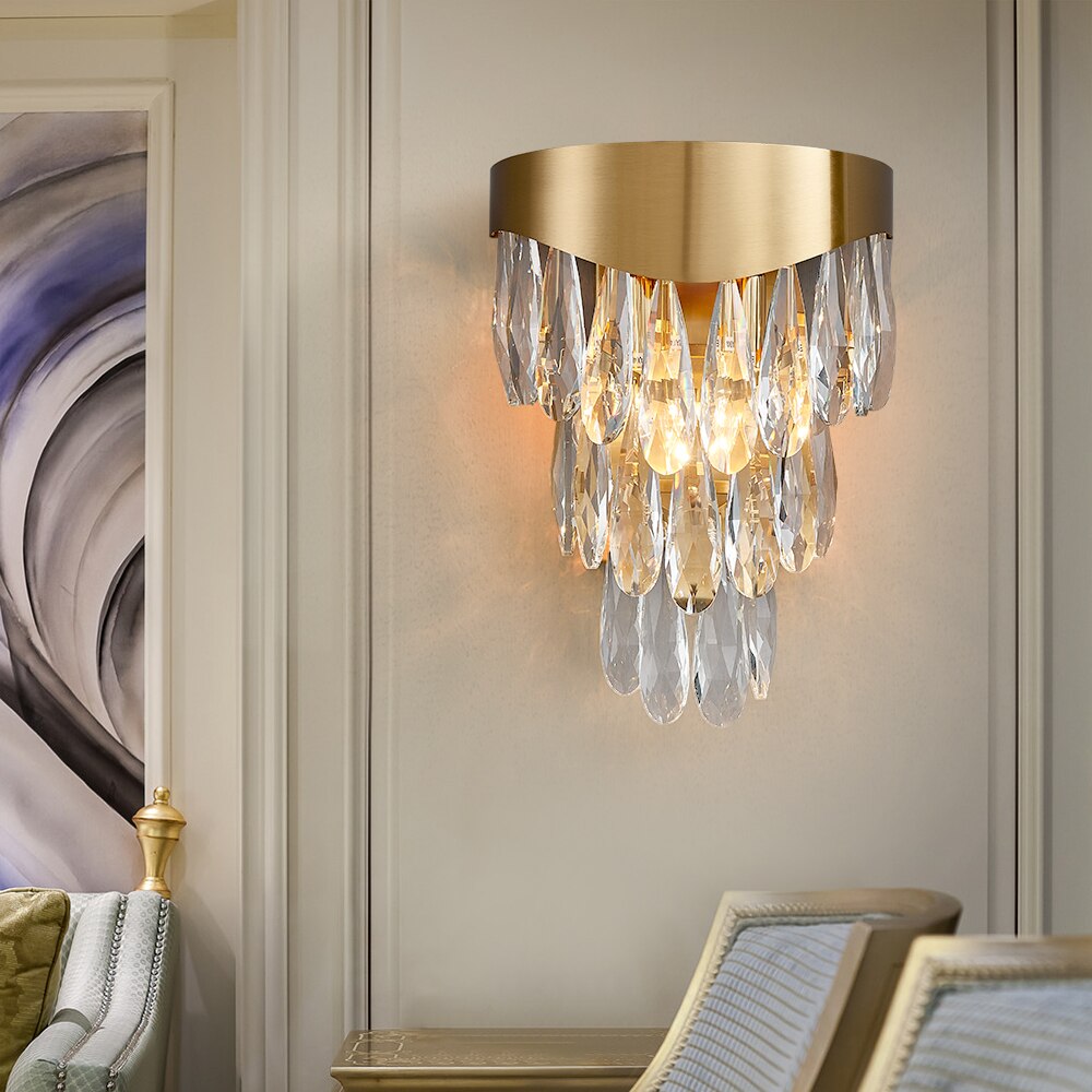 Lomazzo wall light with cascading diamond cut teardrop crystals mounted on a luxury interior wall