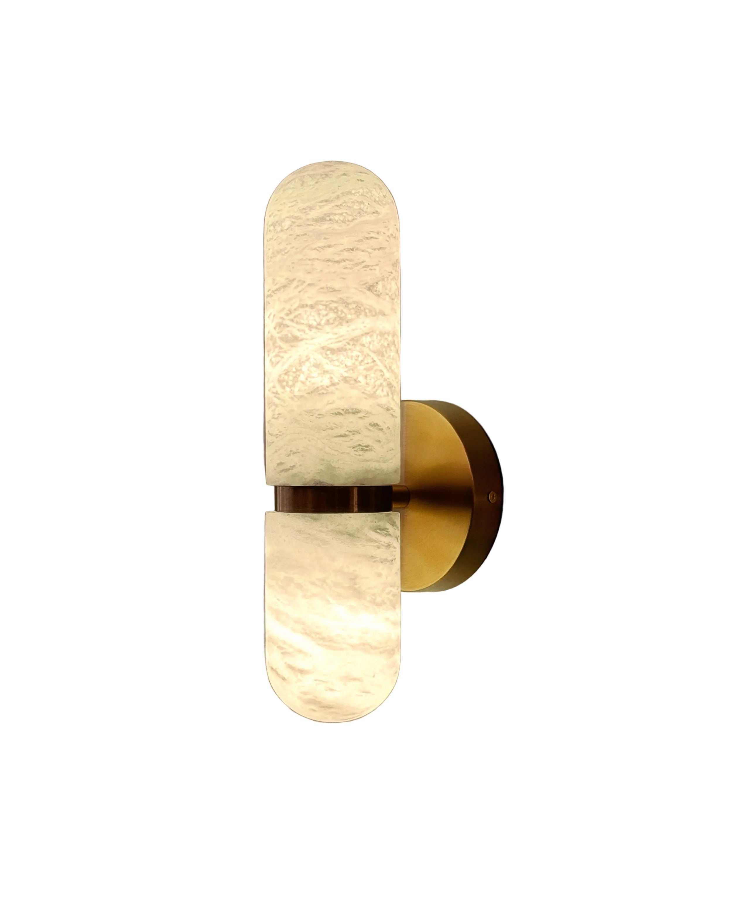 Luma marble wall light with sculpted stone shade and warm brass base illumination