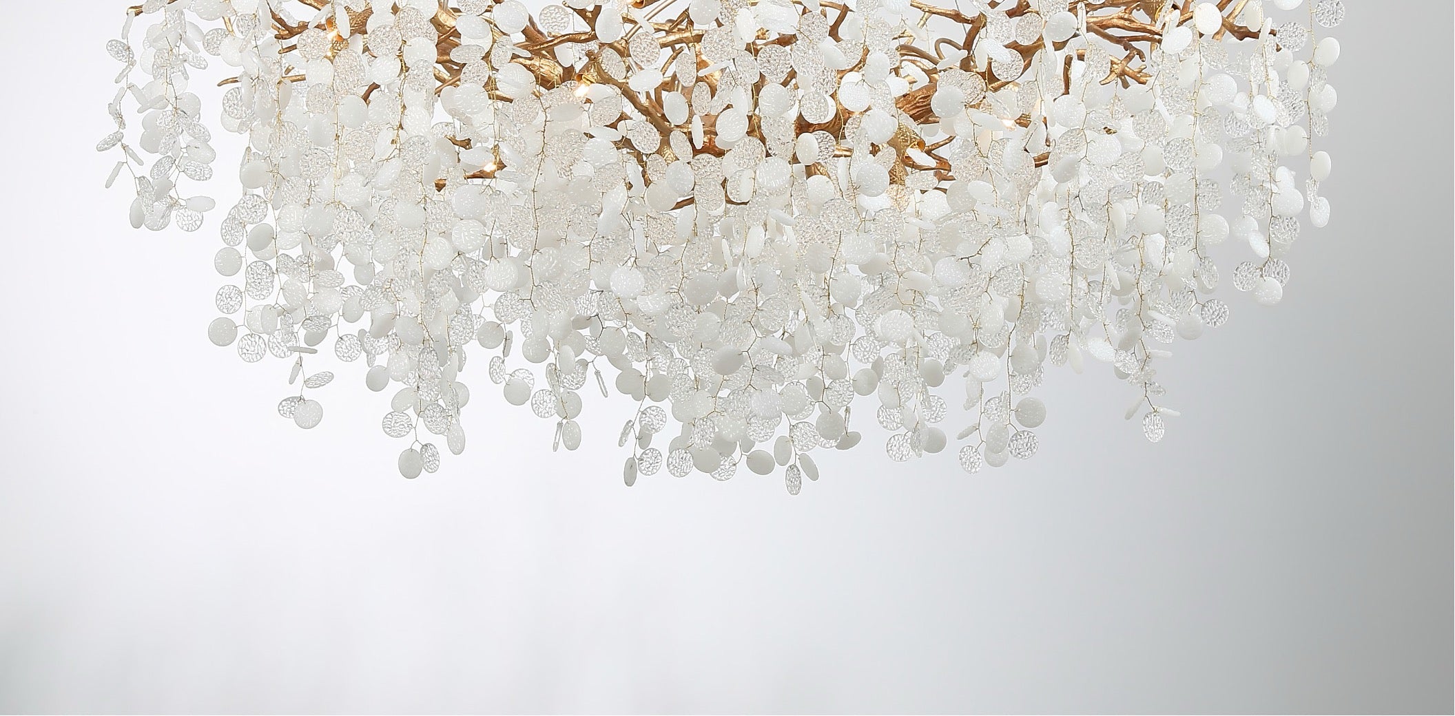 Cascading textured glass discs forming a luxury staircase chandelier