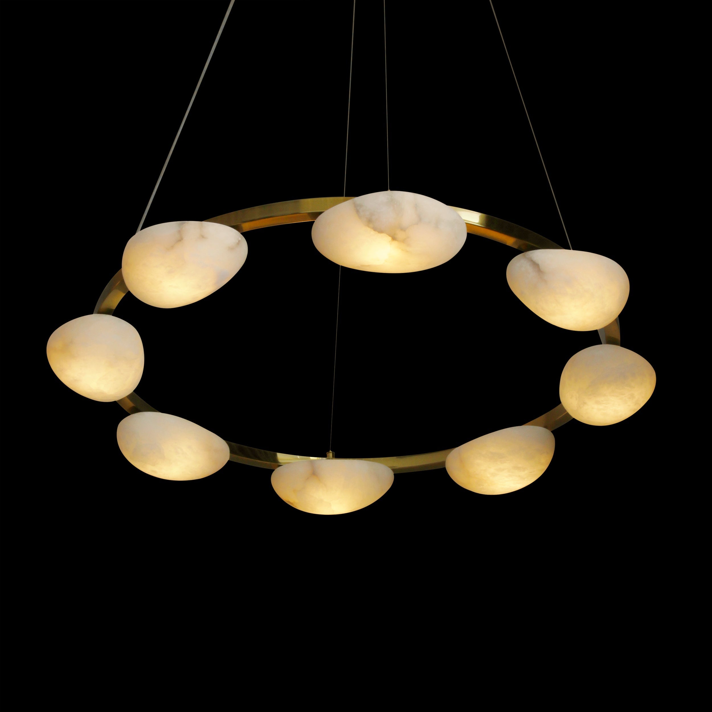 Luxury marble halo chandelier glowing against dark background