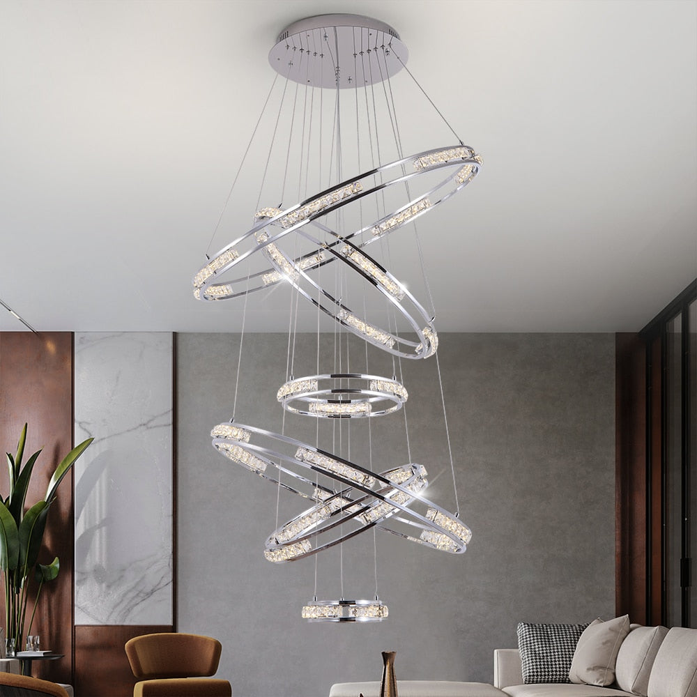 Luxury spiral ring staircase chandelier creating a statement feature within a grand double-height hallway