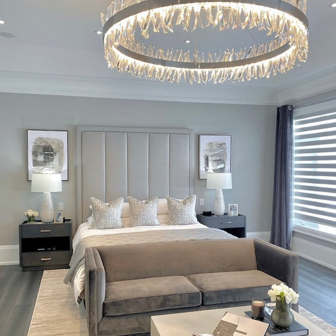 Circular crystal bar chandelier providing soft ambient lighting in a sophisticated bedroom setting