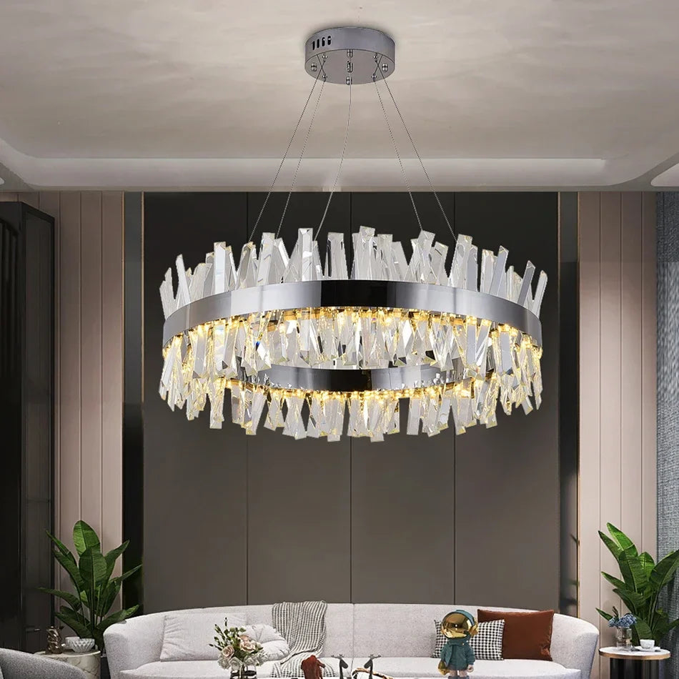 Circular crystal bar chandelier suspended above a contemporary dining table in a refined modern interior