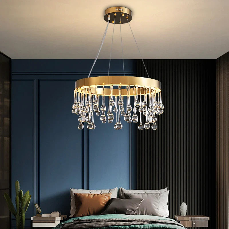 Circular crystal droplet chandelier creating warm ambient lighting in a luxury bedroom