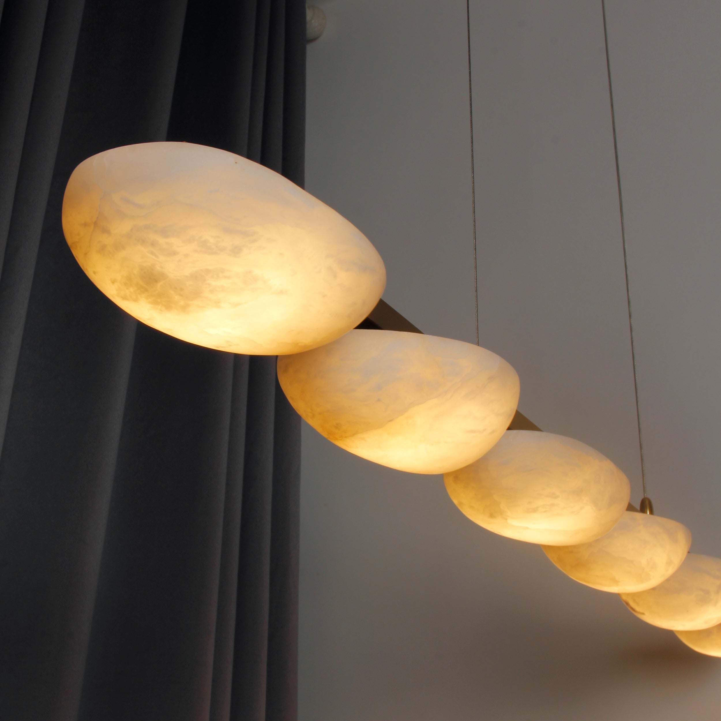 Close up of marble half spheres on rectangular chandelier in Dubai interior