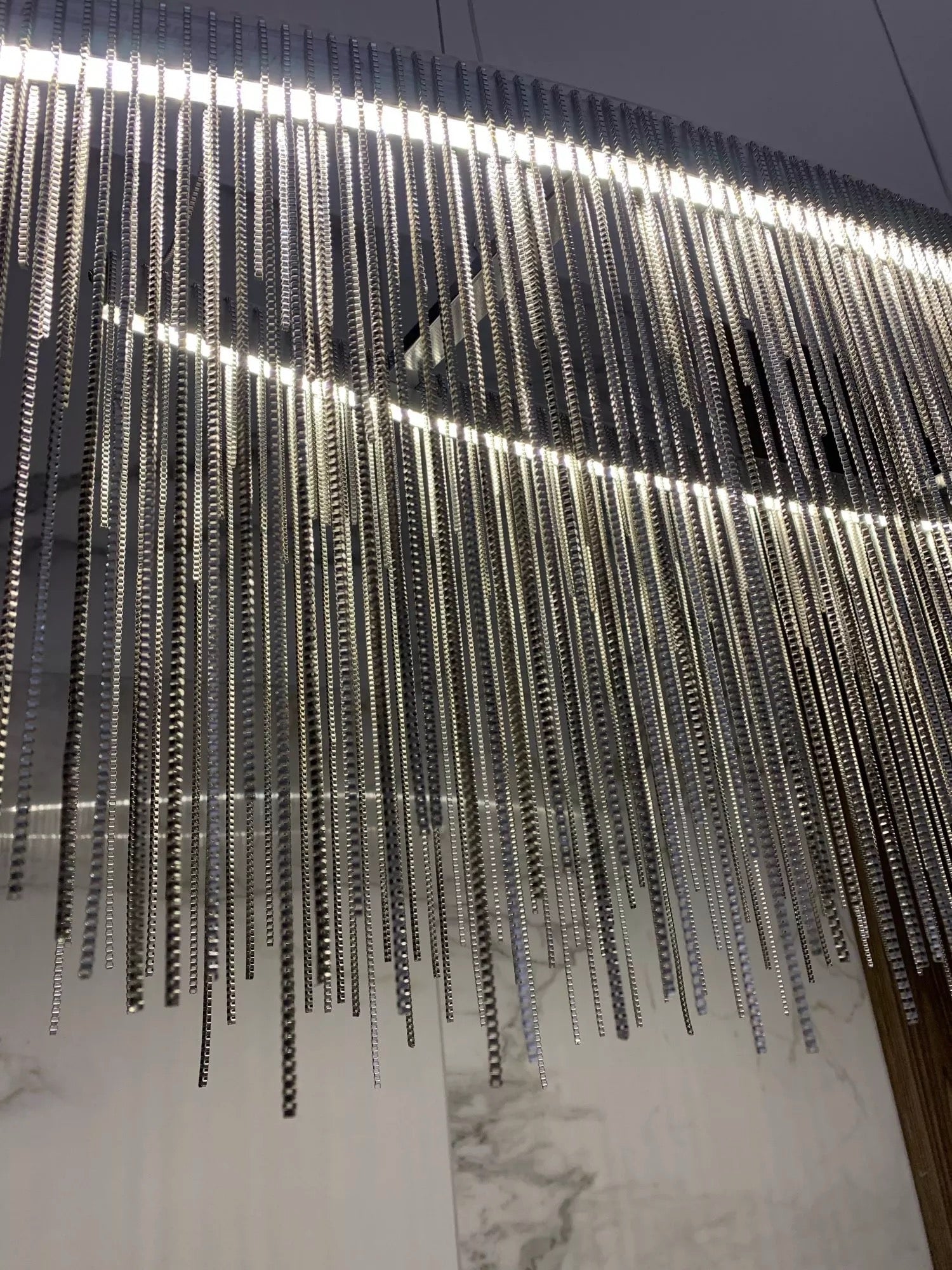 Side angle of modern cascading chain chandelier in UAE