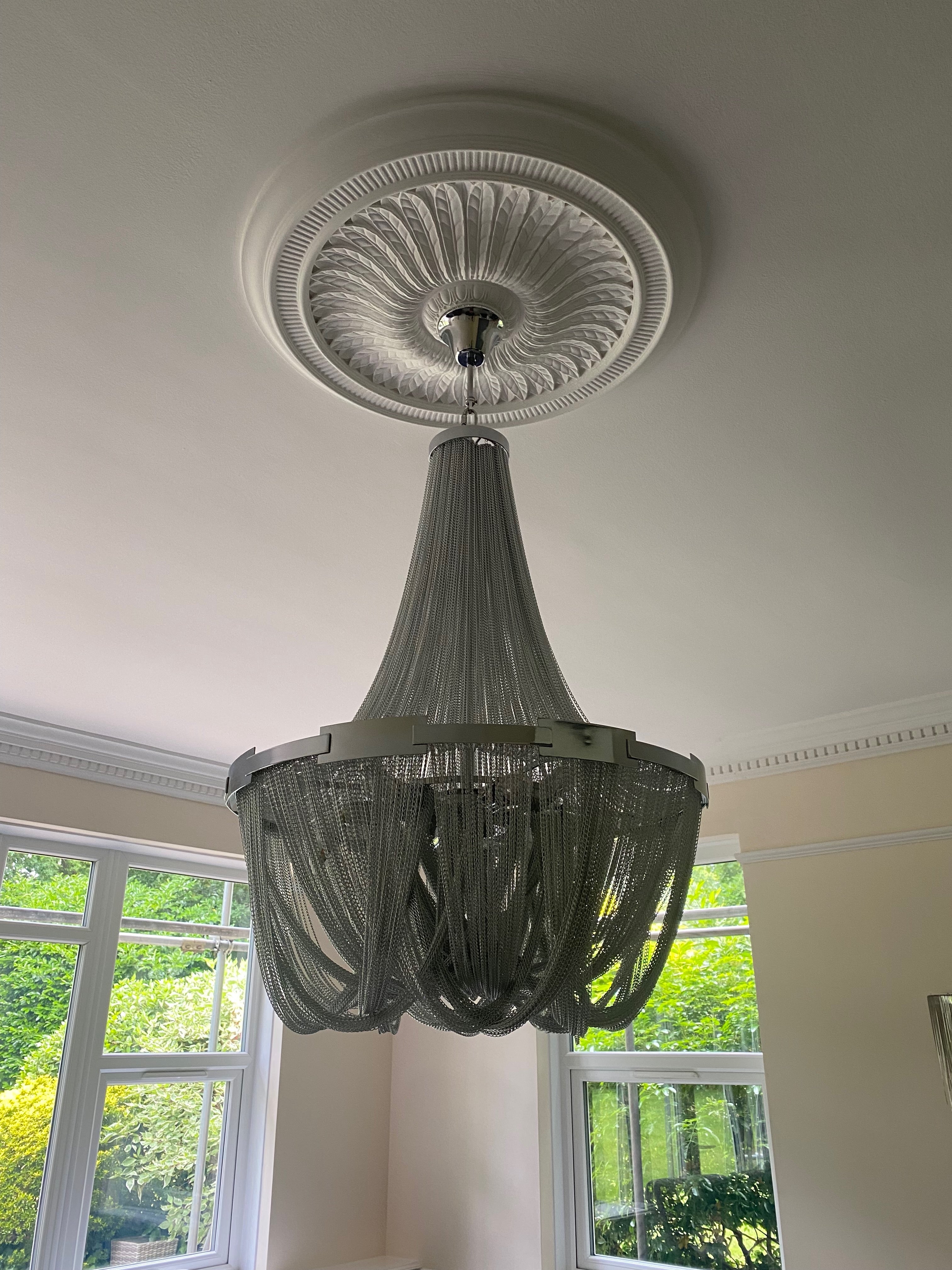 Modern luxury staircase chandelier illuminating UAE foyer