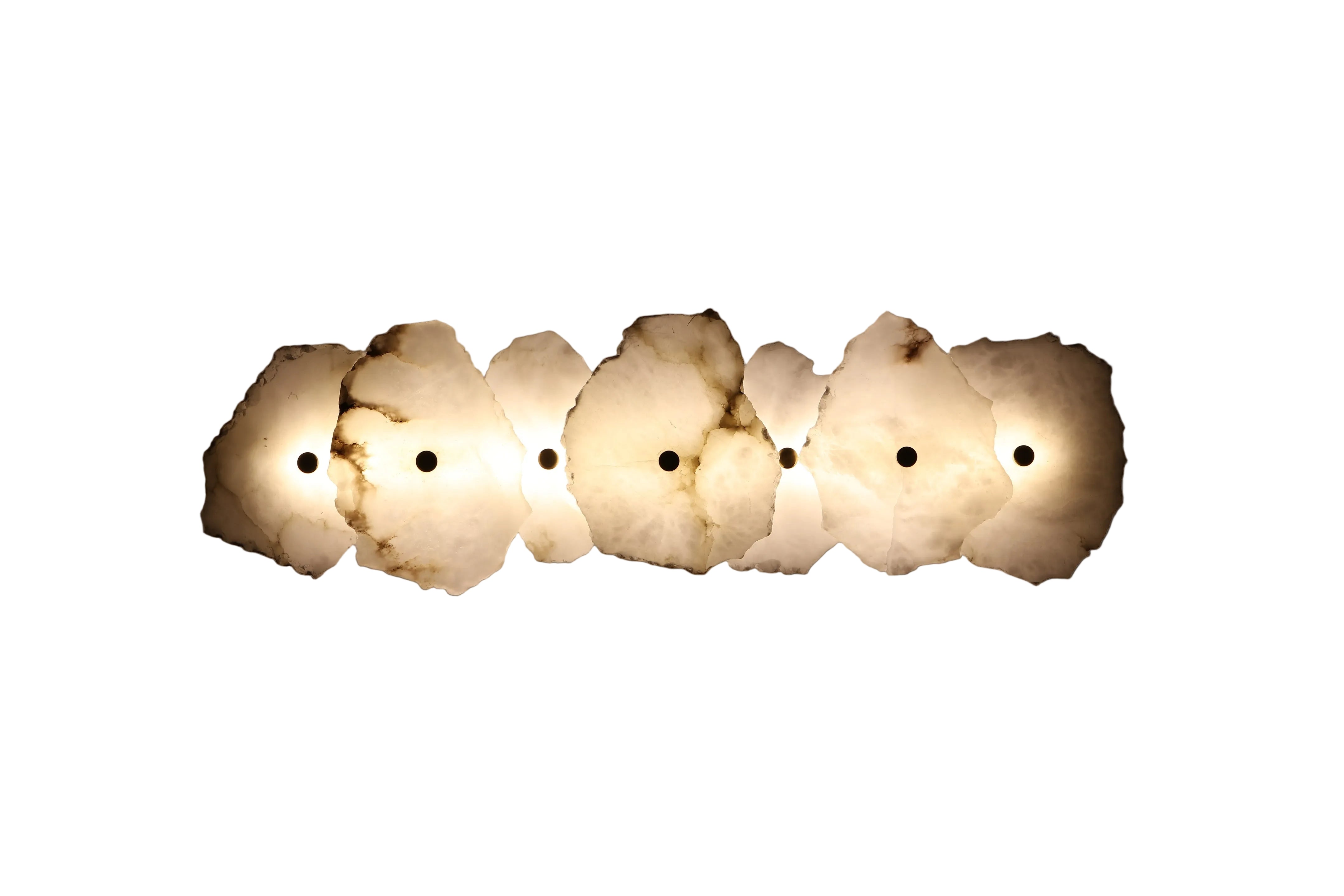 Silvio marble wall light featuring handcrafted natural stone panels arranged in sculptural horizontal formation on white background