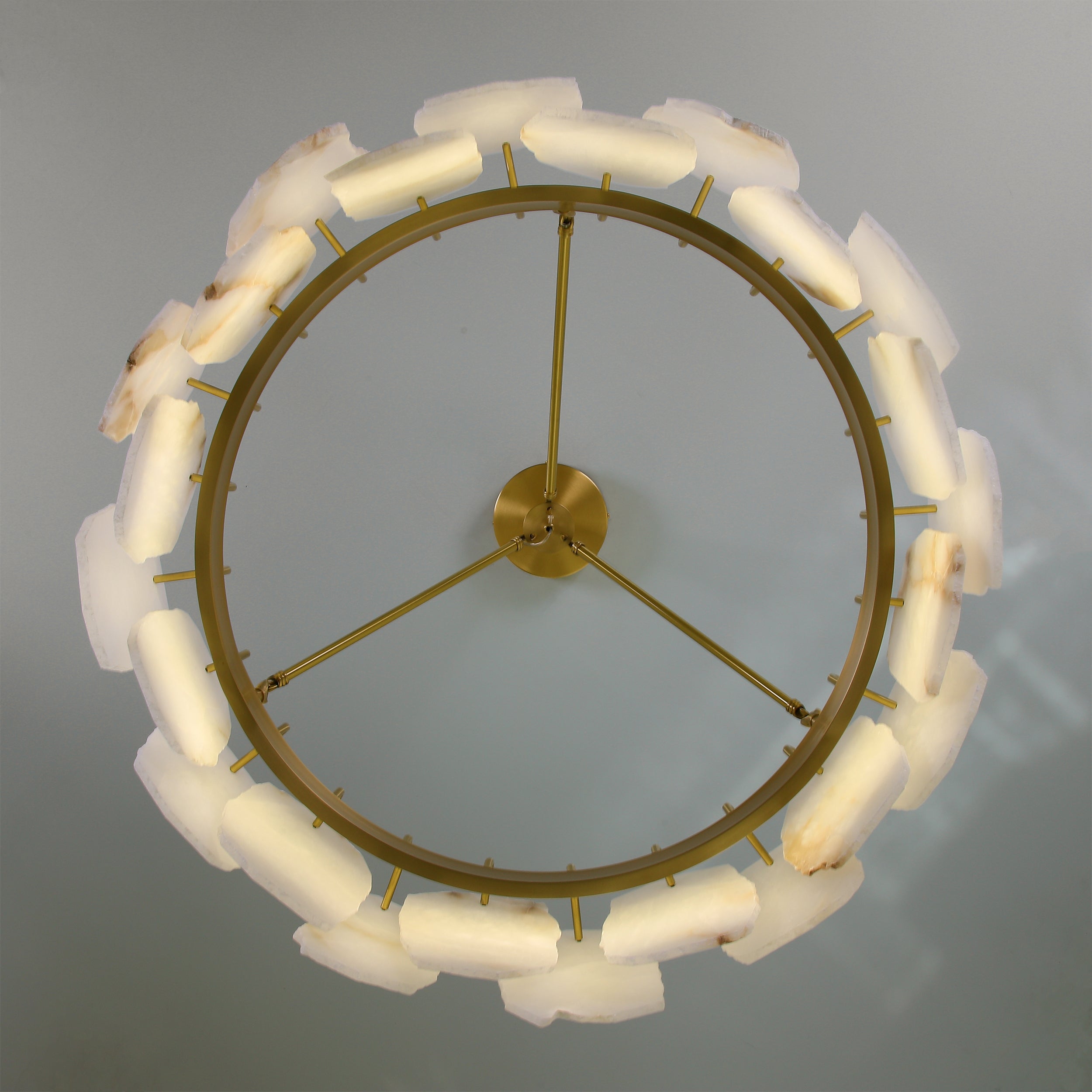 Underside view of Silvio Marble Circular Chandelier II highlighting circular frame and carved marble elements