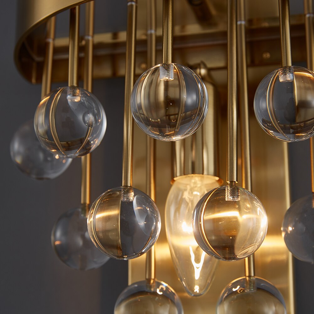 Close up crystal sphere detailing on Alytus Wall Light gold frame
