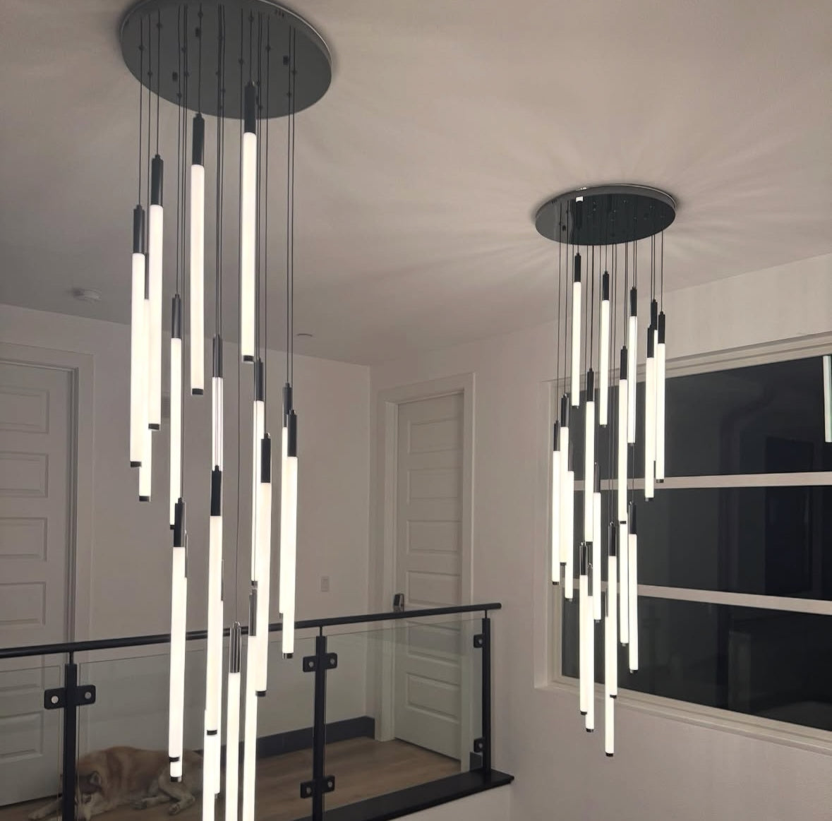 Luxury Avezzano pendant staircase lighting featuring multiple vertical drops in a contemporary interior