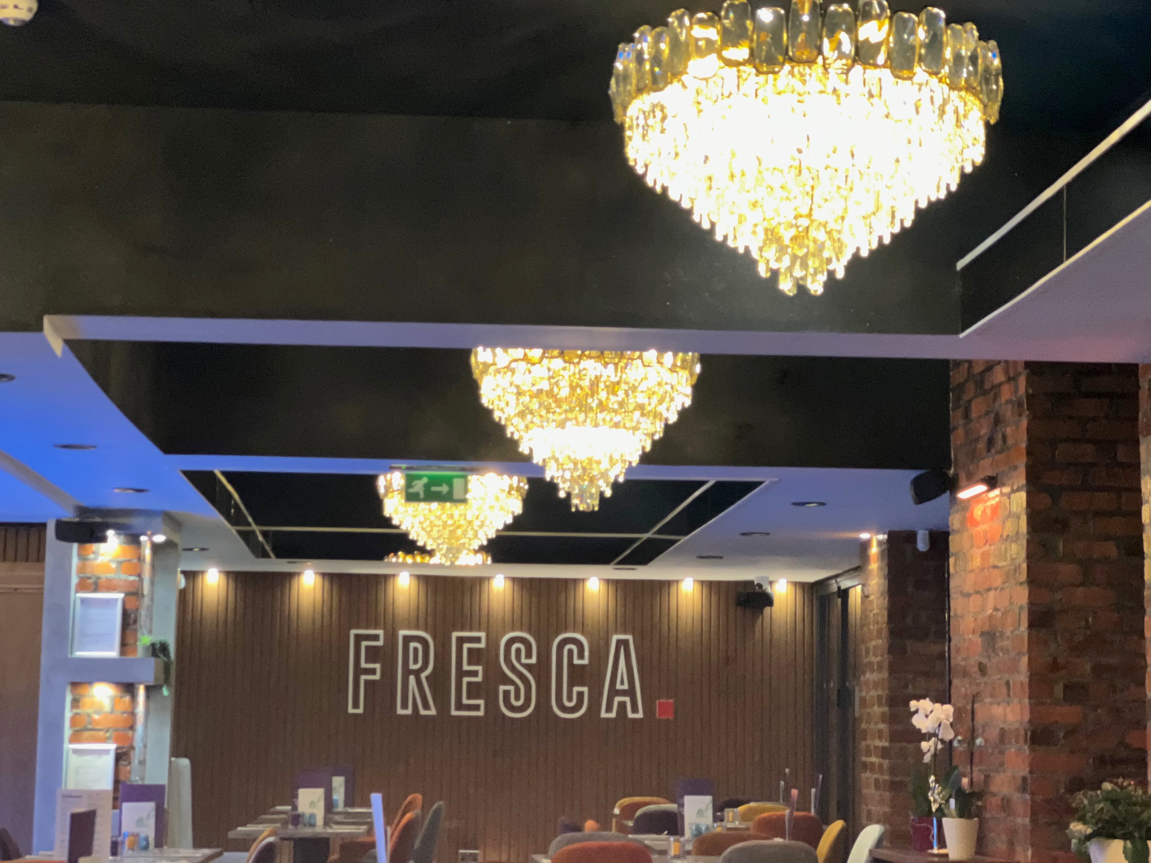 VORELLI Edmond circular chandeliers illuminating luxury hospitality dining space
