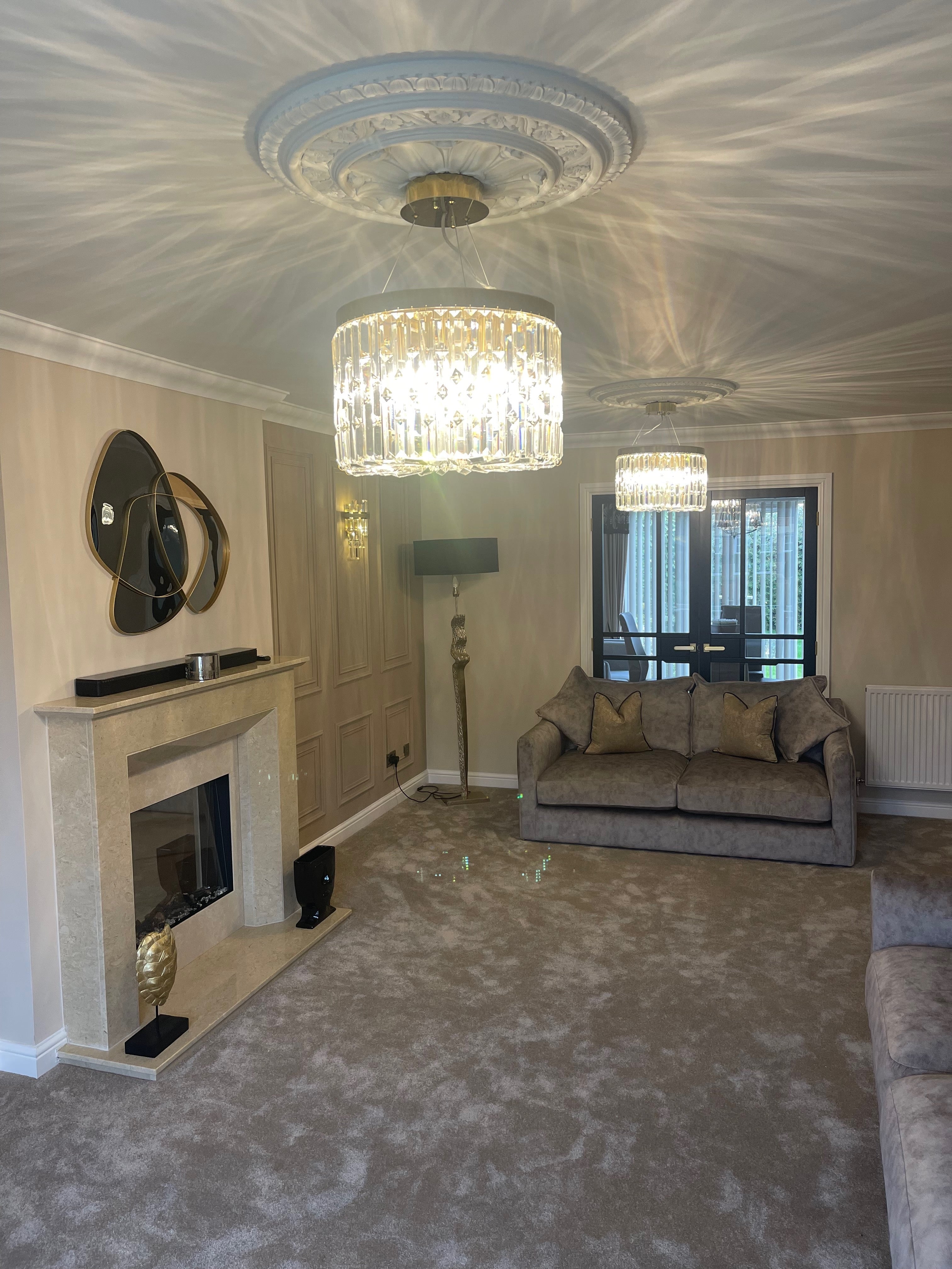 Luxury crystal ceiling light casting decorative reflections across a modern living room