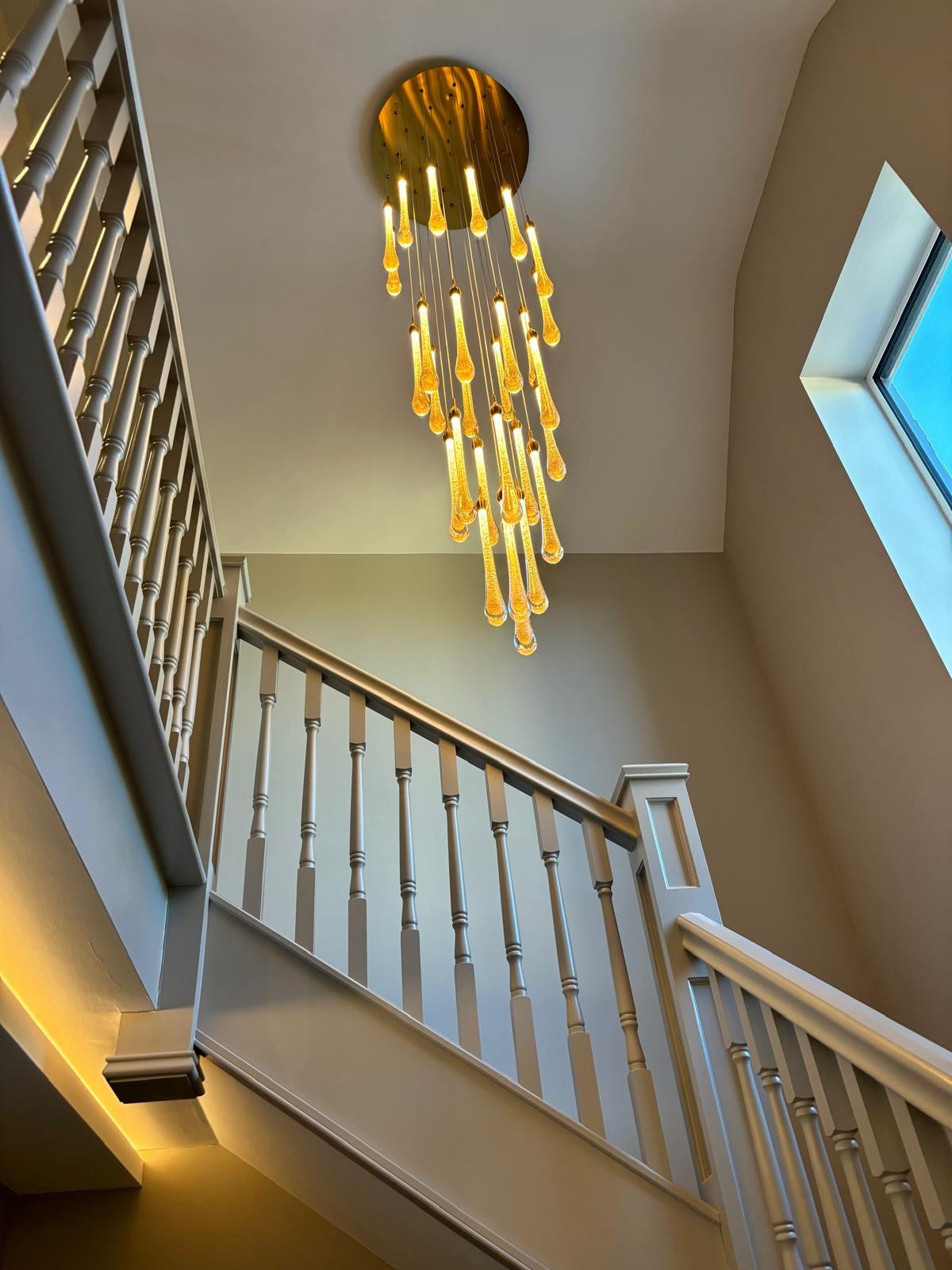 Modern stairwell chandelier with gold glass pendants from VORELLI Foshan collection